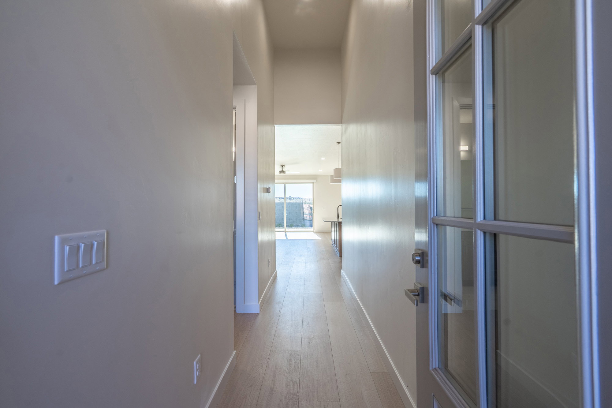 Hallway with baseboards and light wood finished floors
