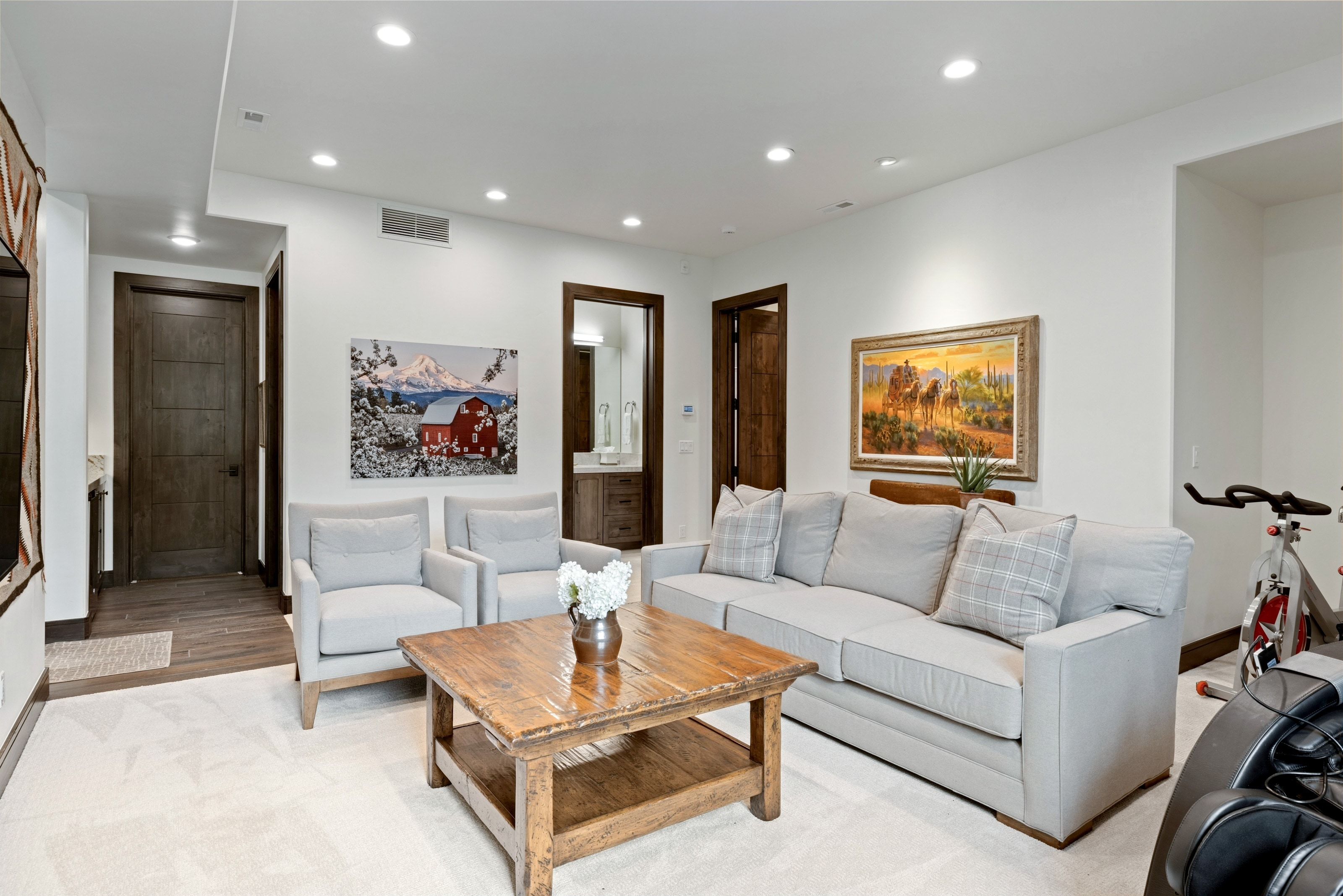 Carpeted living area featuring recessed lighting, a built-in wall niche, and dark wood-finish doors