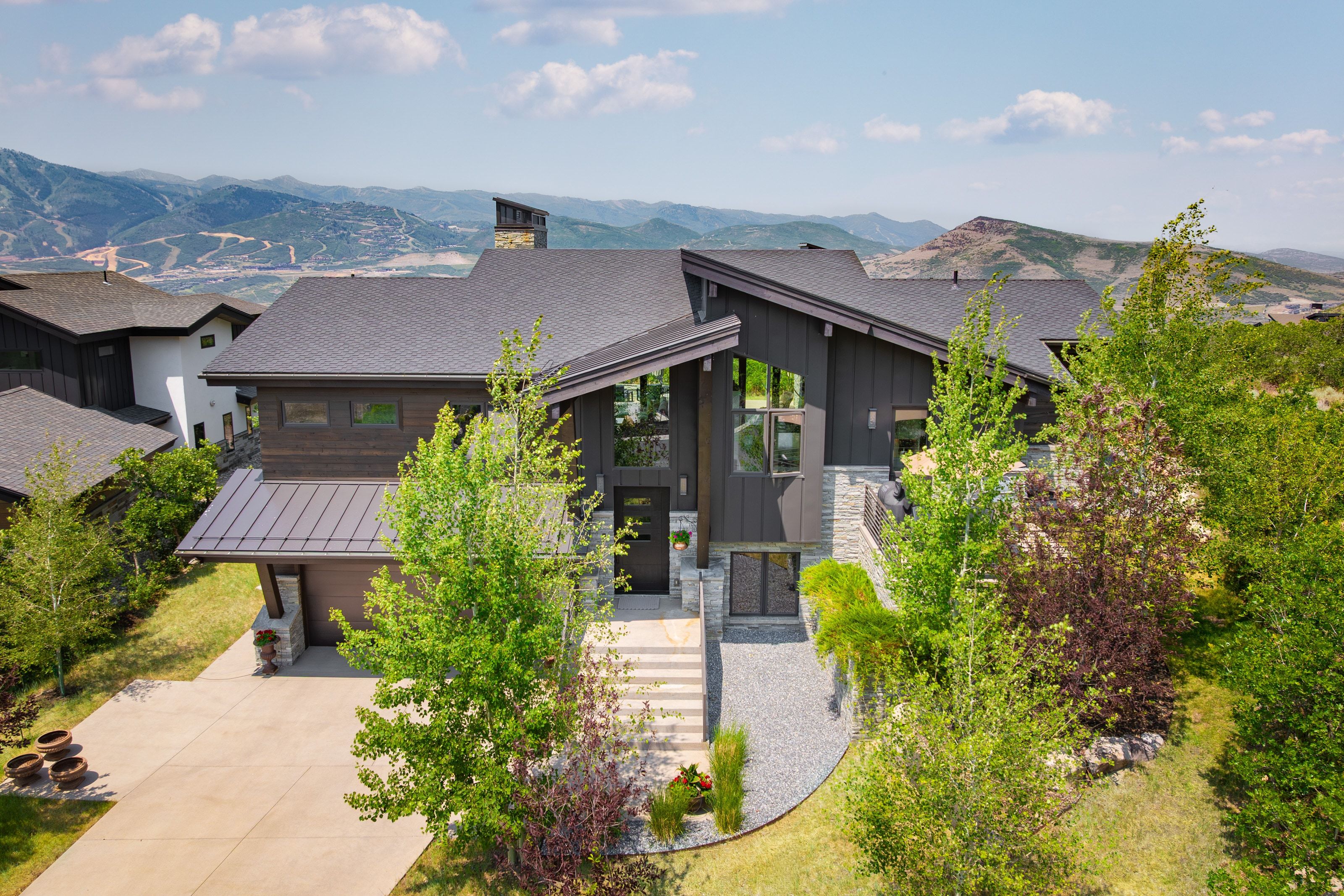 Contemporary exterior with dark siding and stone accents