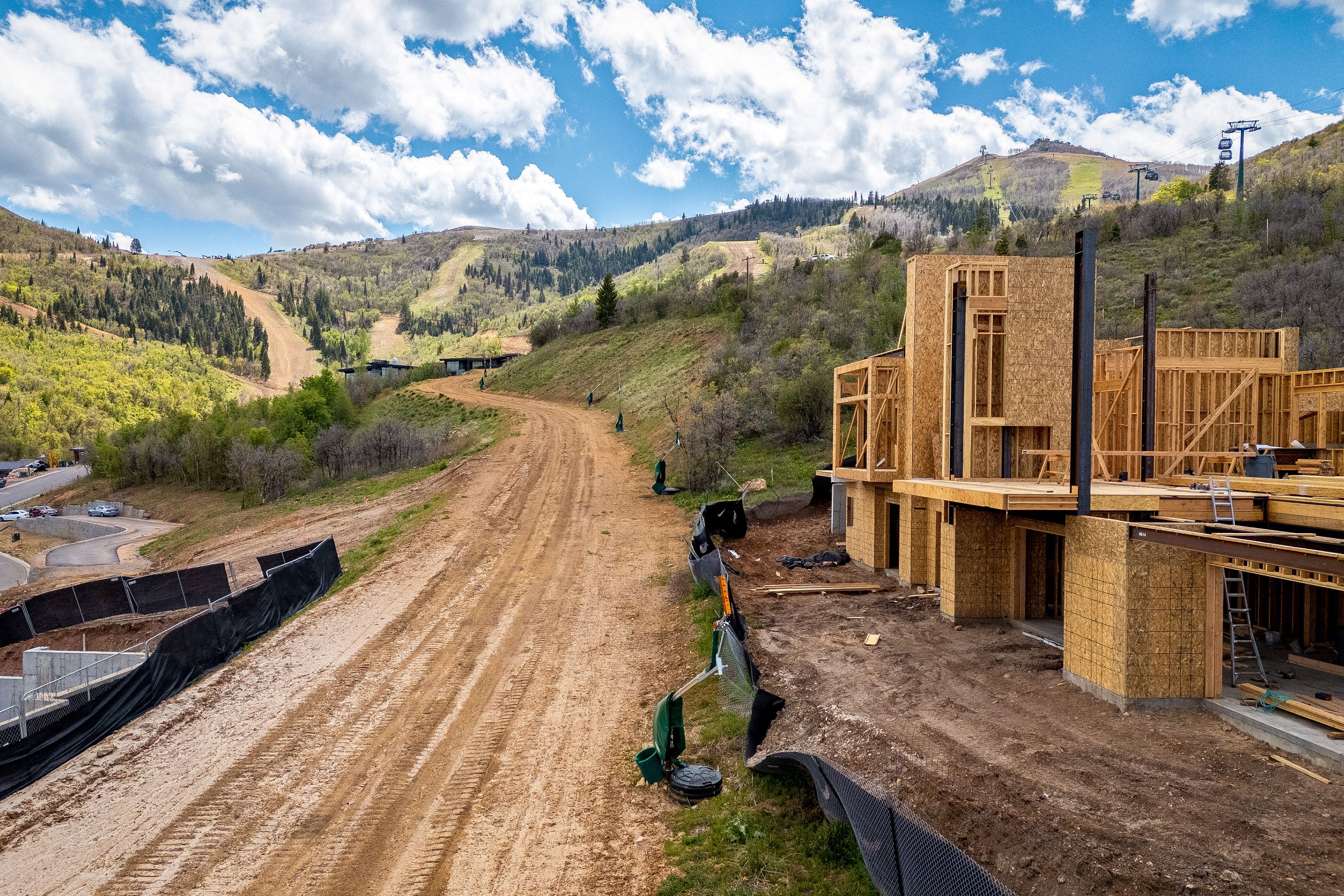 New construction framing against a mountainous backdrop