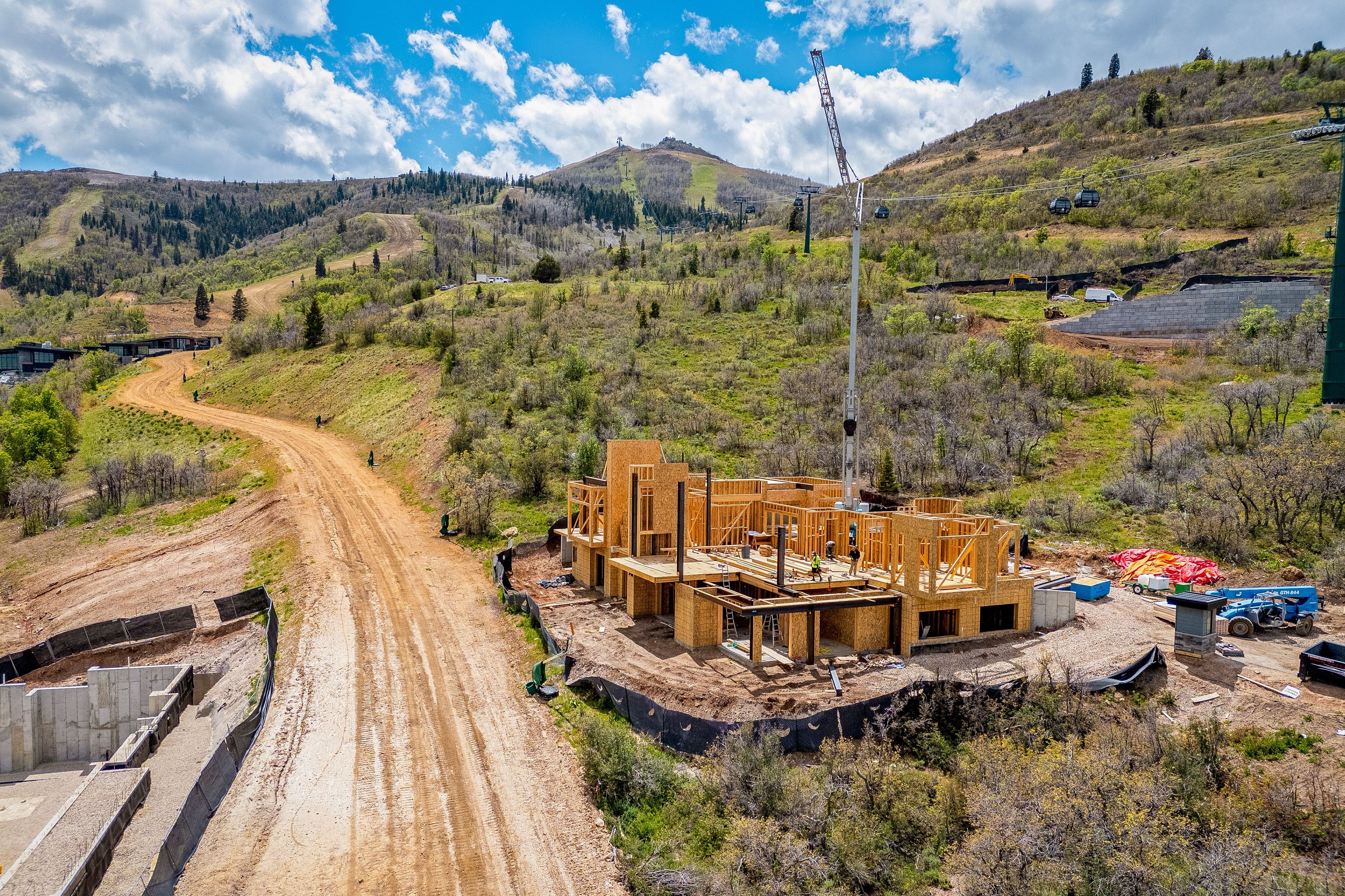 New construction framing underway, featuring a multi-level structure and a concrete foundation