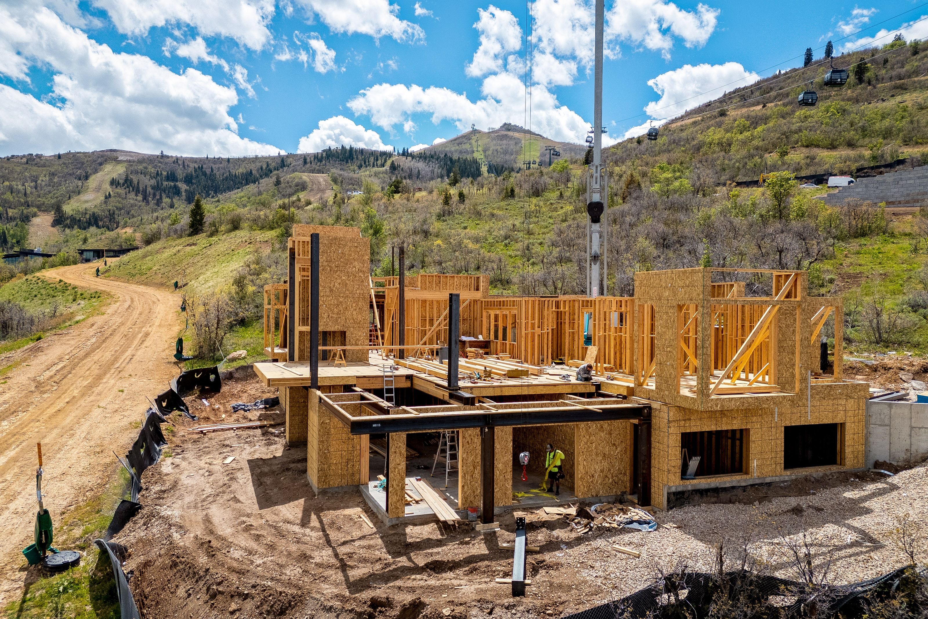 New construction property featuring wood framing, steel structural elements, and a concrete foundation