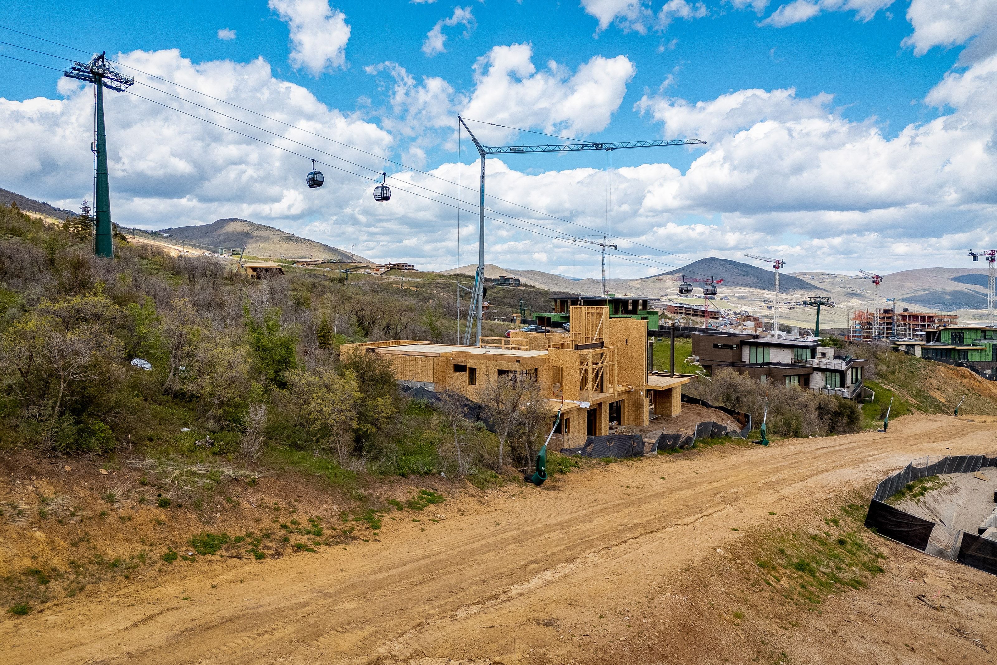 Mountainous terrain featuring developing properties and a visible ski lift system