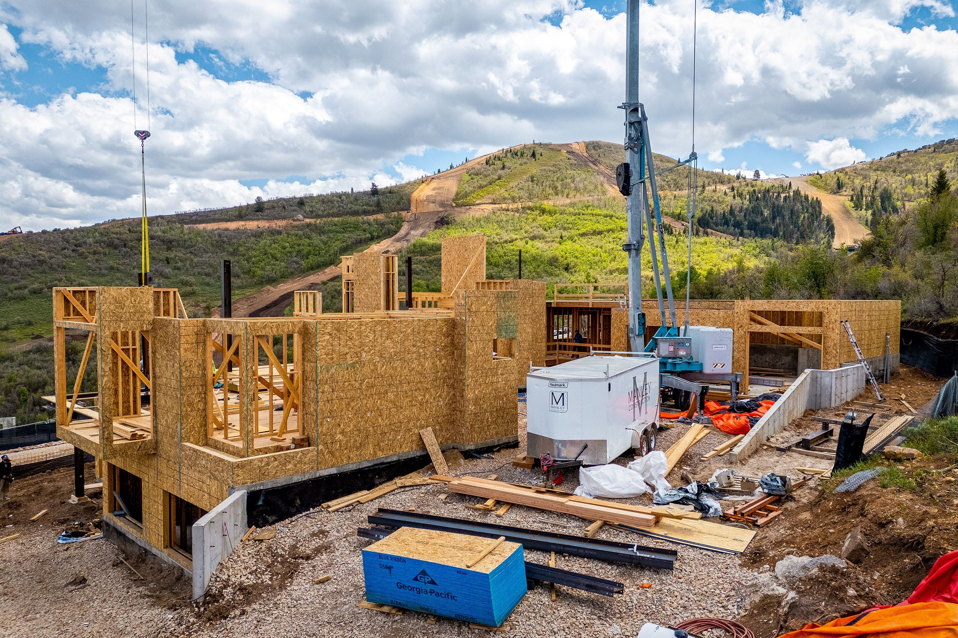 Framed residential structure under construction featuring wood sheathing