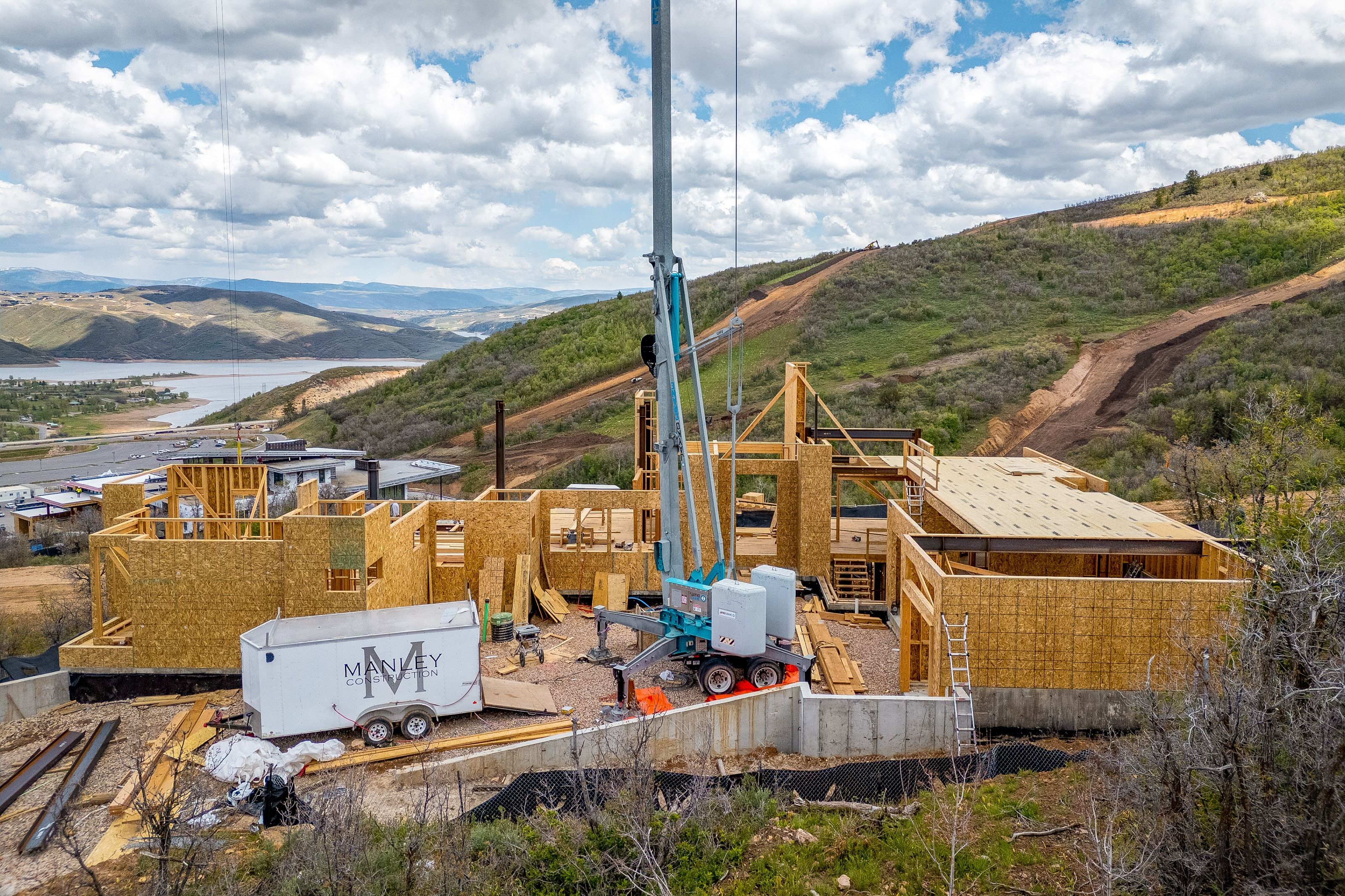 New construction framing with panoramic mountain and lake scenery
