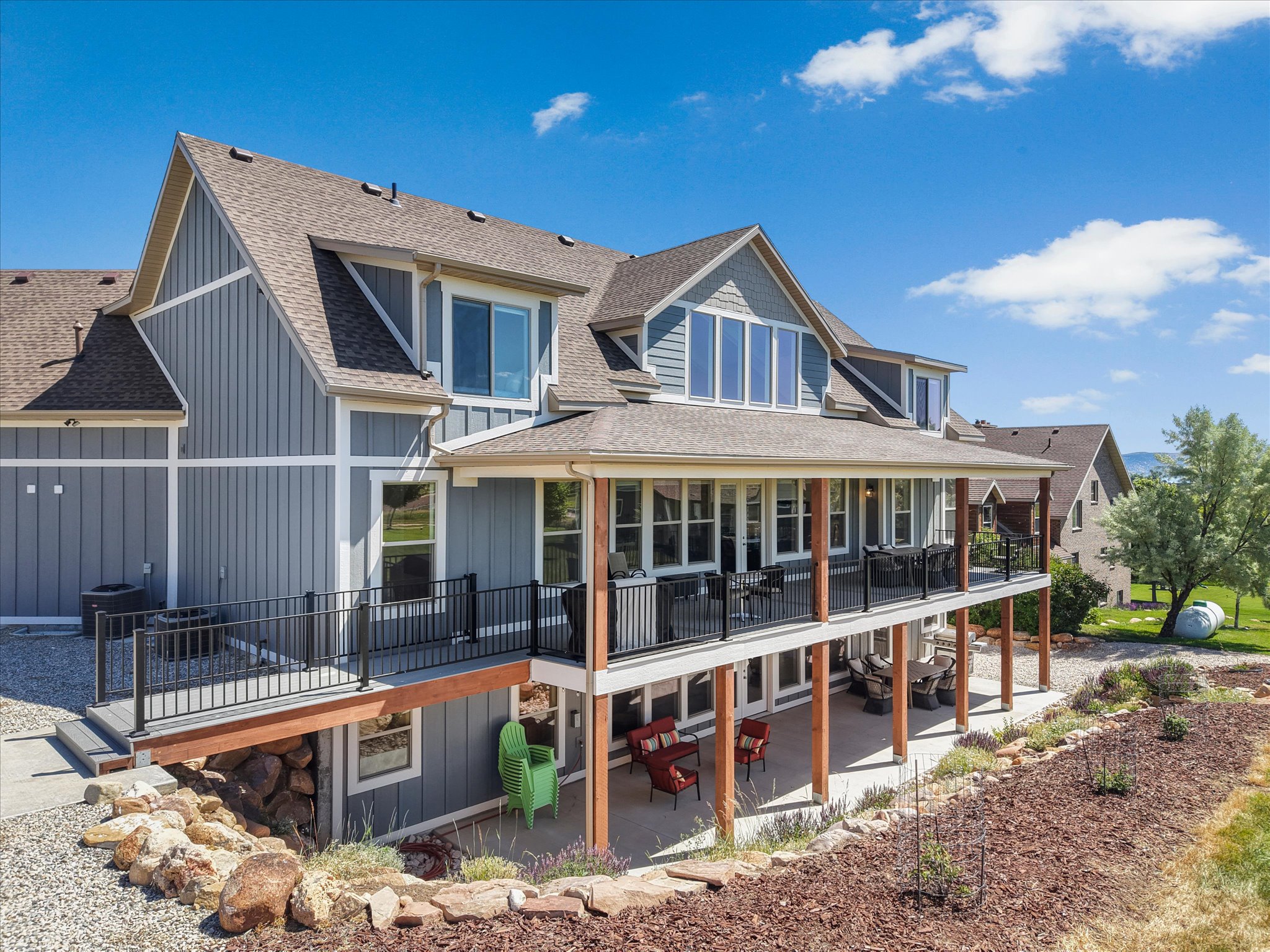 Multi-story exterior featuring gray siding with white trim