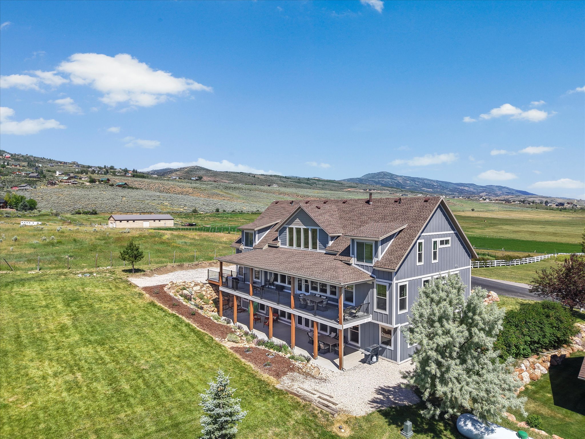 Two-story residence featuring horizontal siding and a multi-level deck