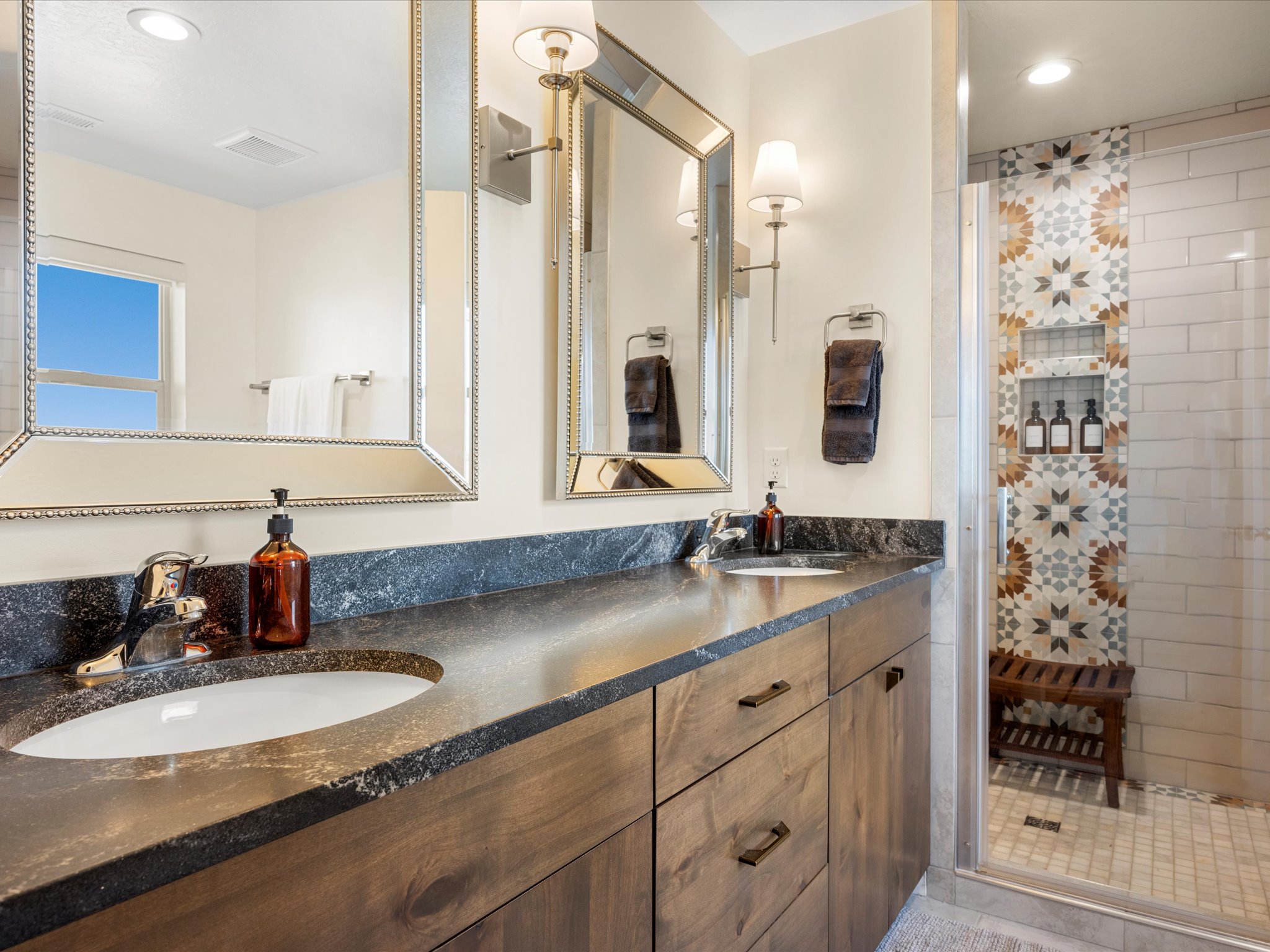 Dual vanity with dark stone-finish countertop and undermount sinks