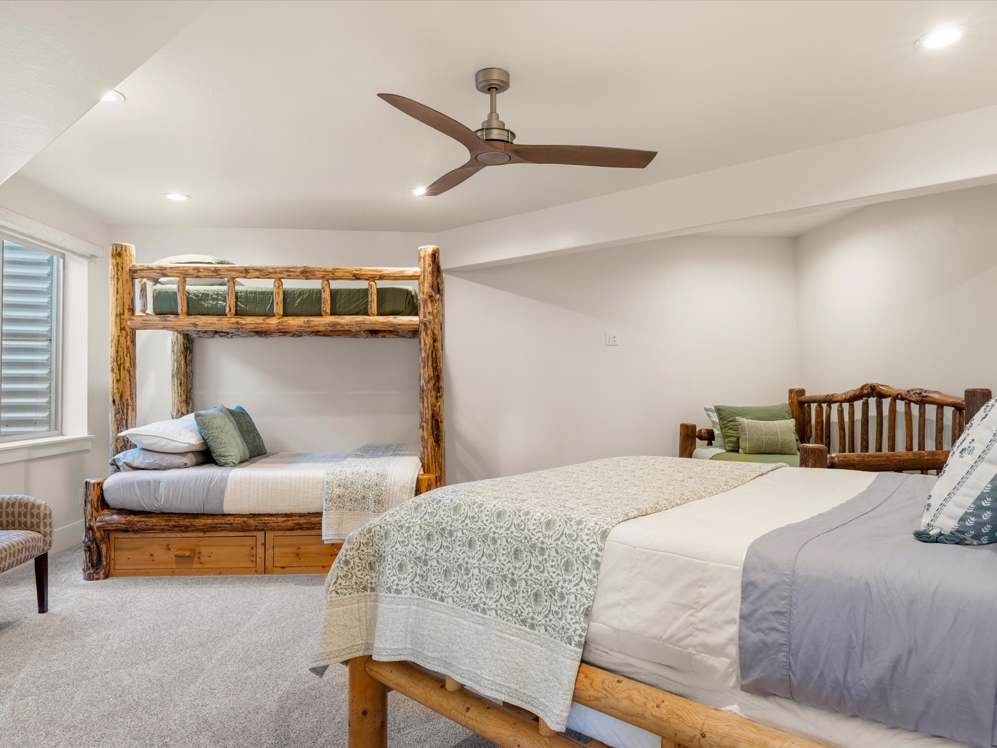 Bedroom featuring a rustic wood bunk bed with integrated storage drawers and a coordinating wood bed frame