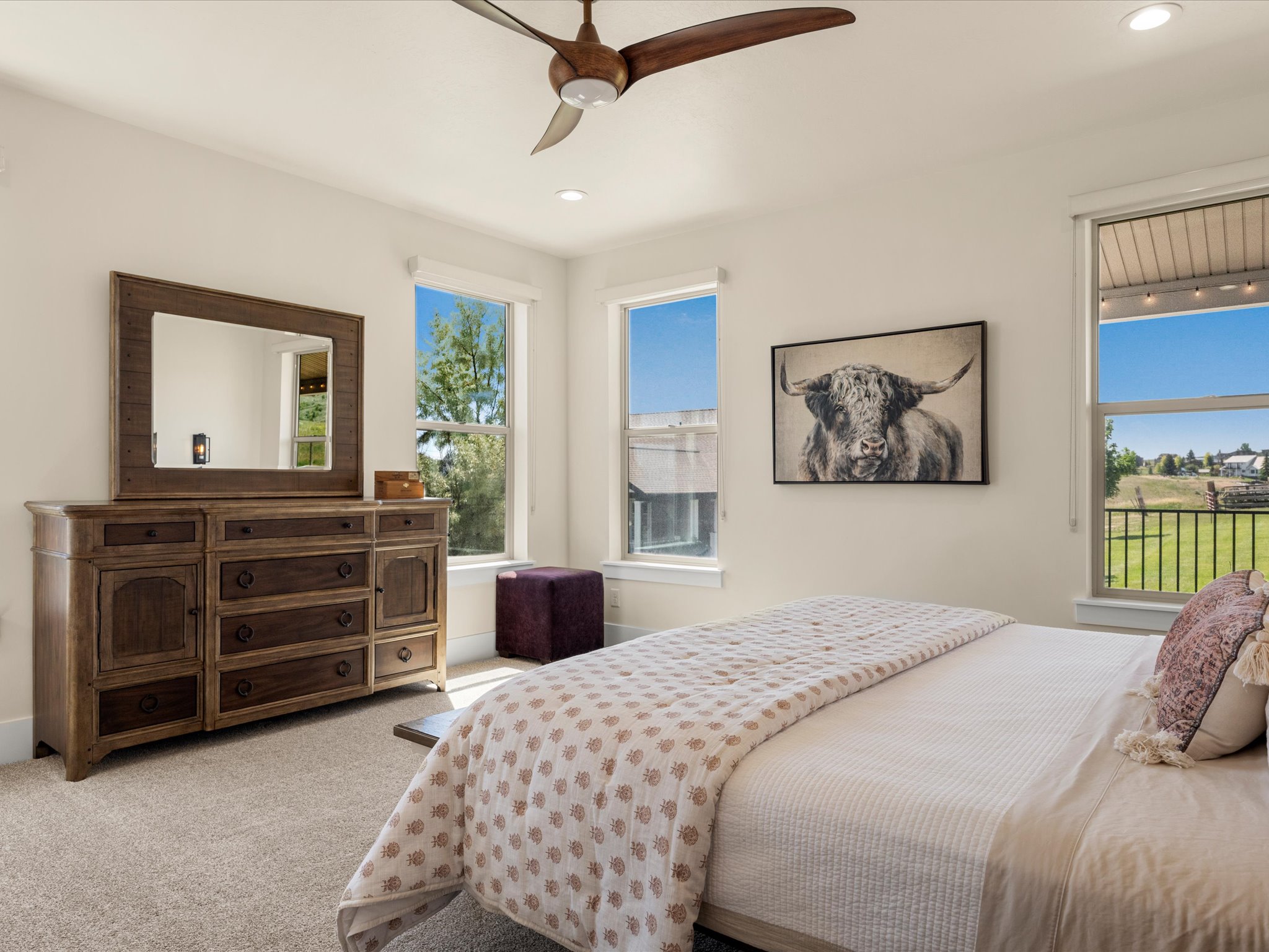 Bright bedroom featuring multiple windows, recessed lighting, and a ceiling fan