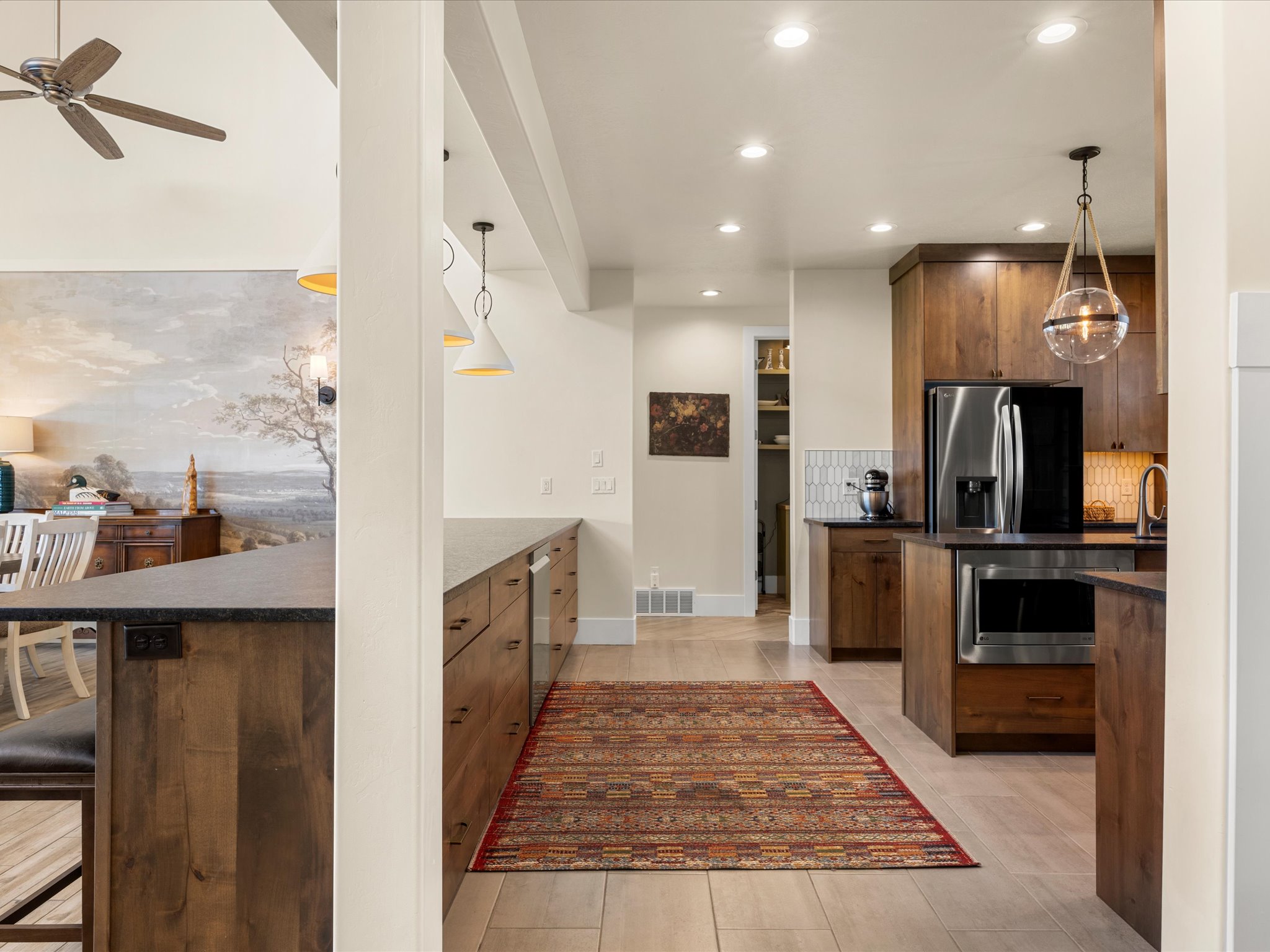 Modern kitchen featuring wood cabinetry, stainless steel appliances, recessed lighting, and light wood-finish tile flooring