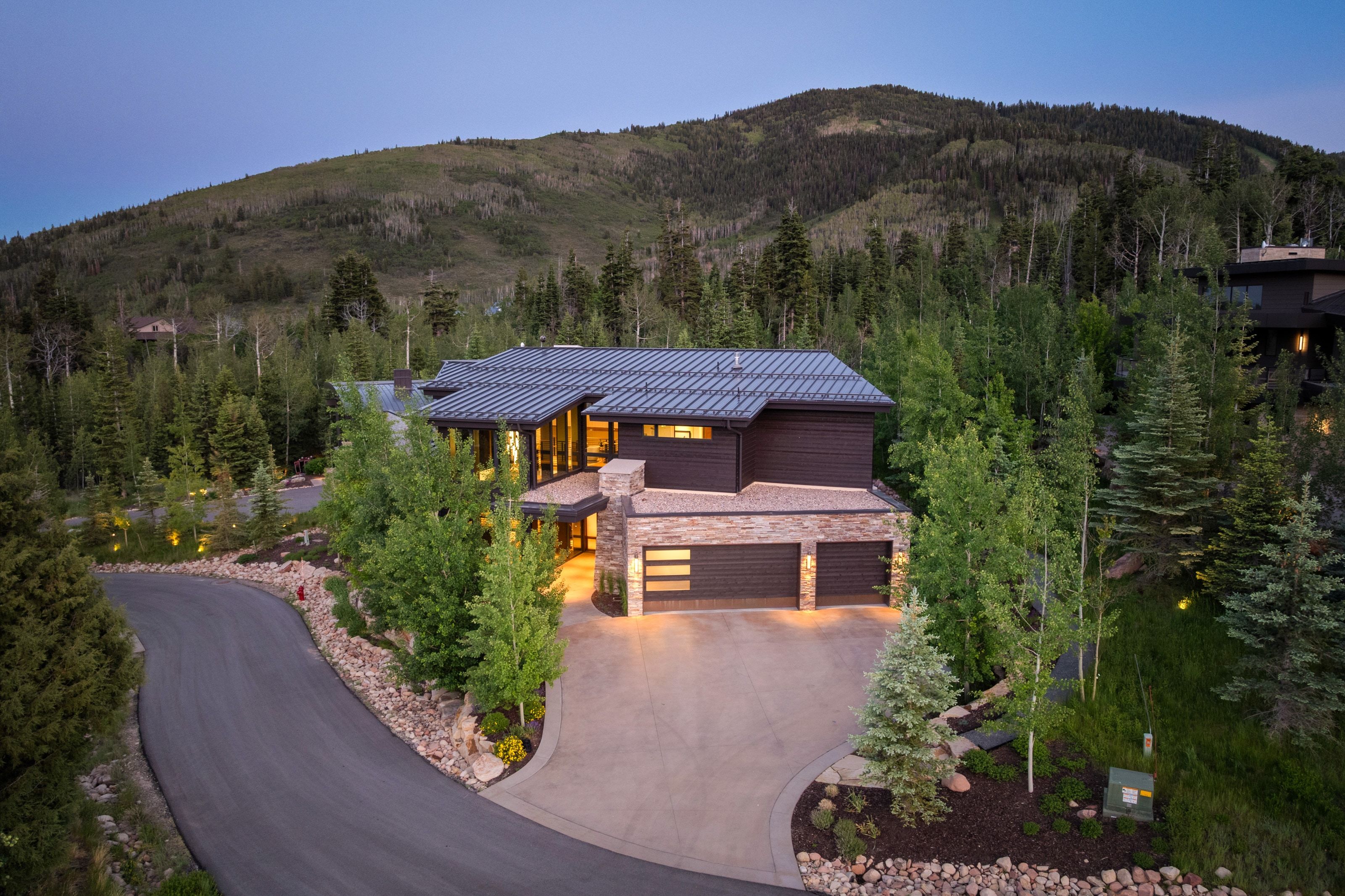 Contemporary mountain residence featuring a stone and wood exterior