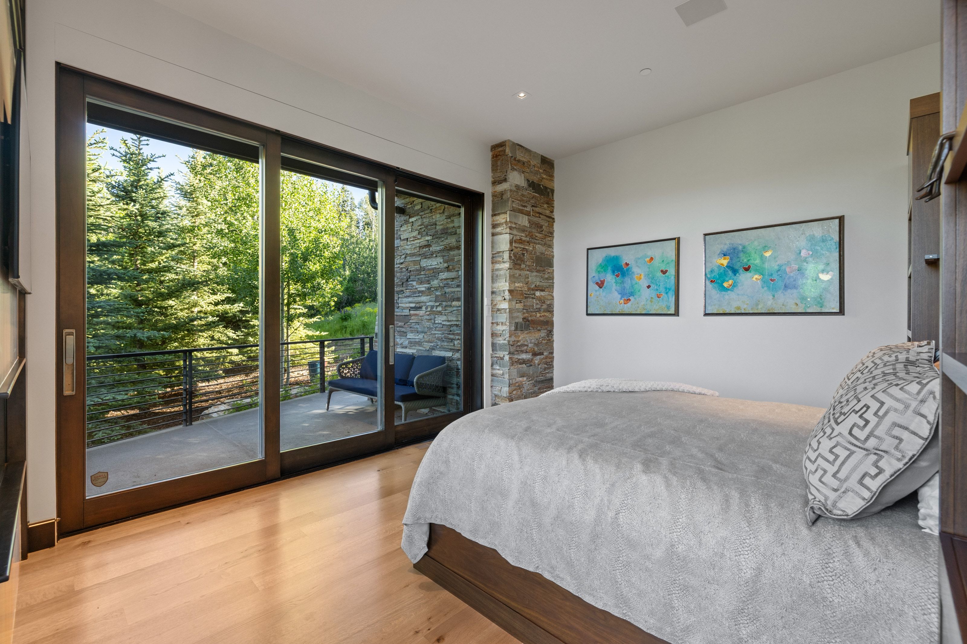 Sliding glass door opening to an outdoor patio with a cable railing system