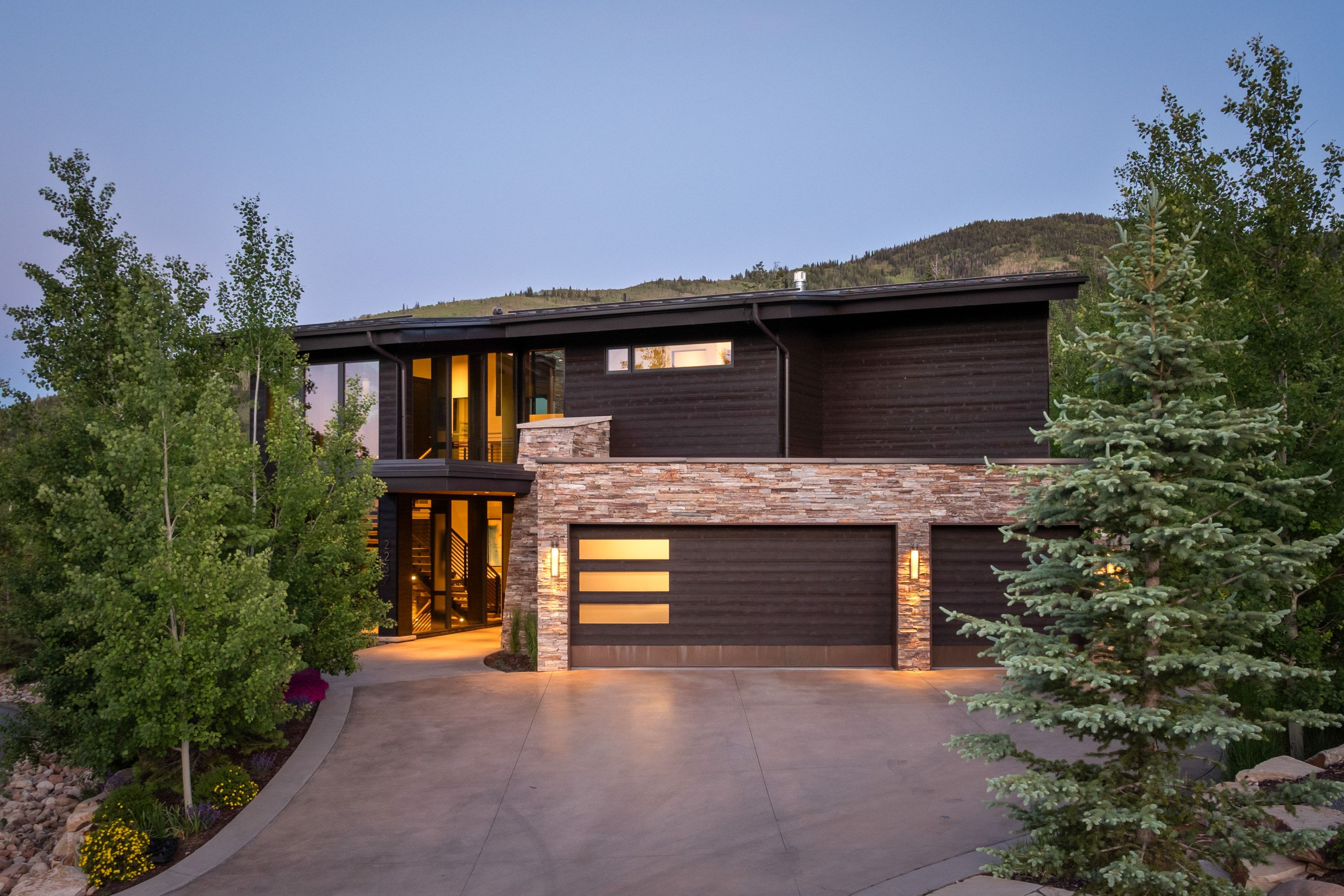 Modern facade featuring dark horizontal siding and stone accents