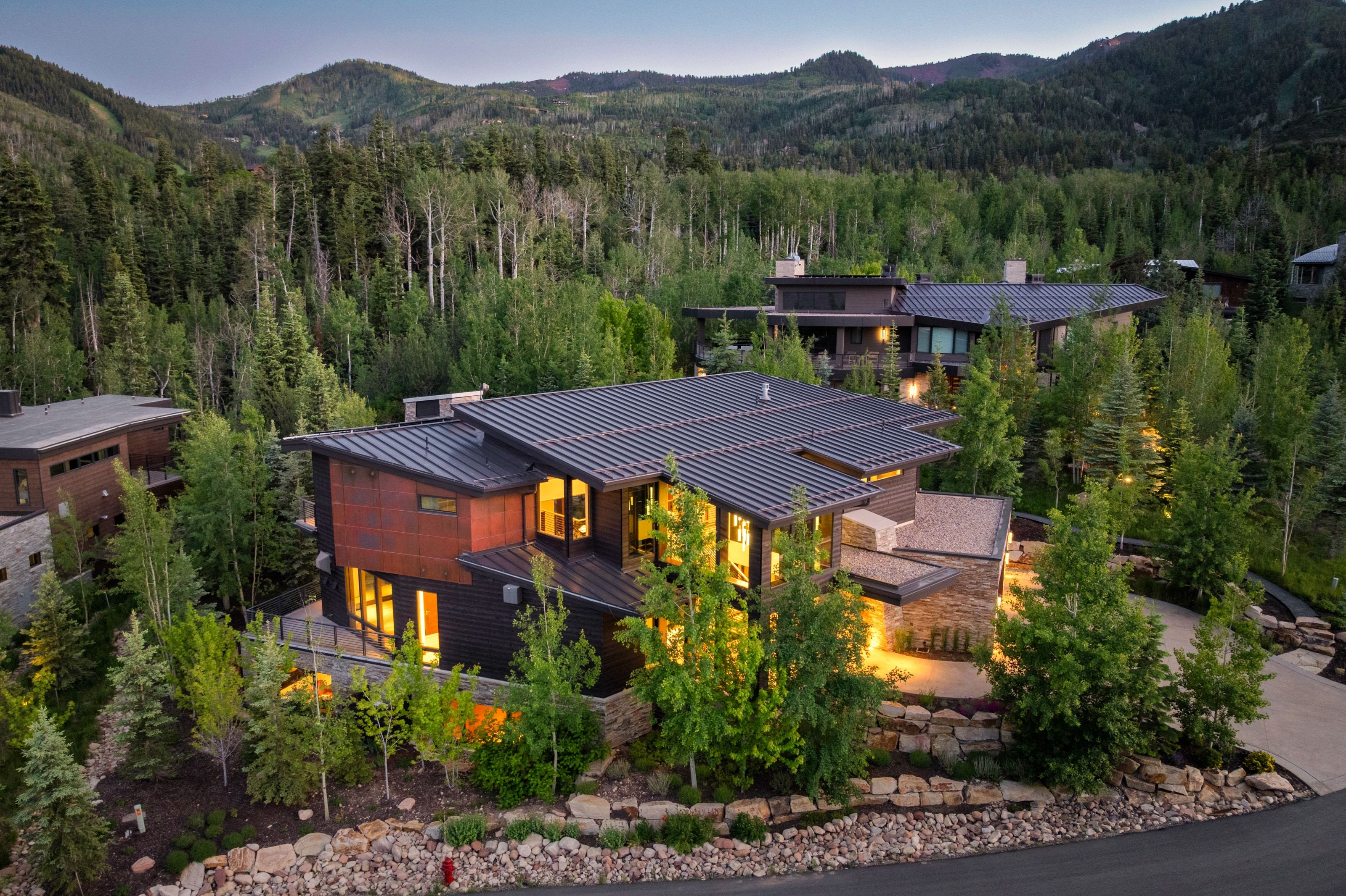 Modern residence featuring a dark metal roof and copper-toned siding