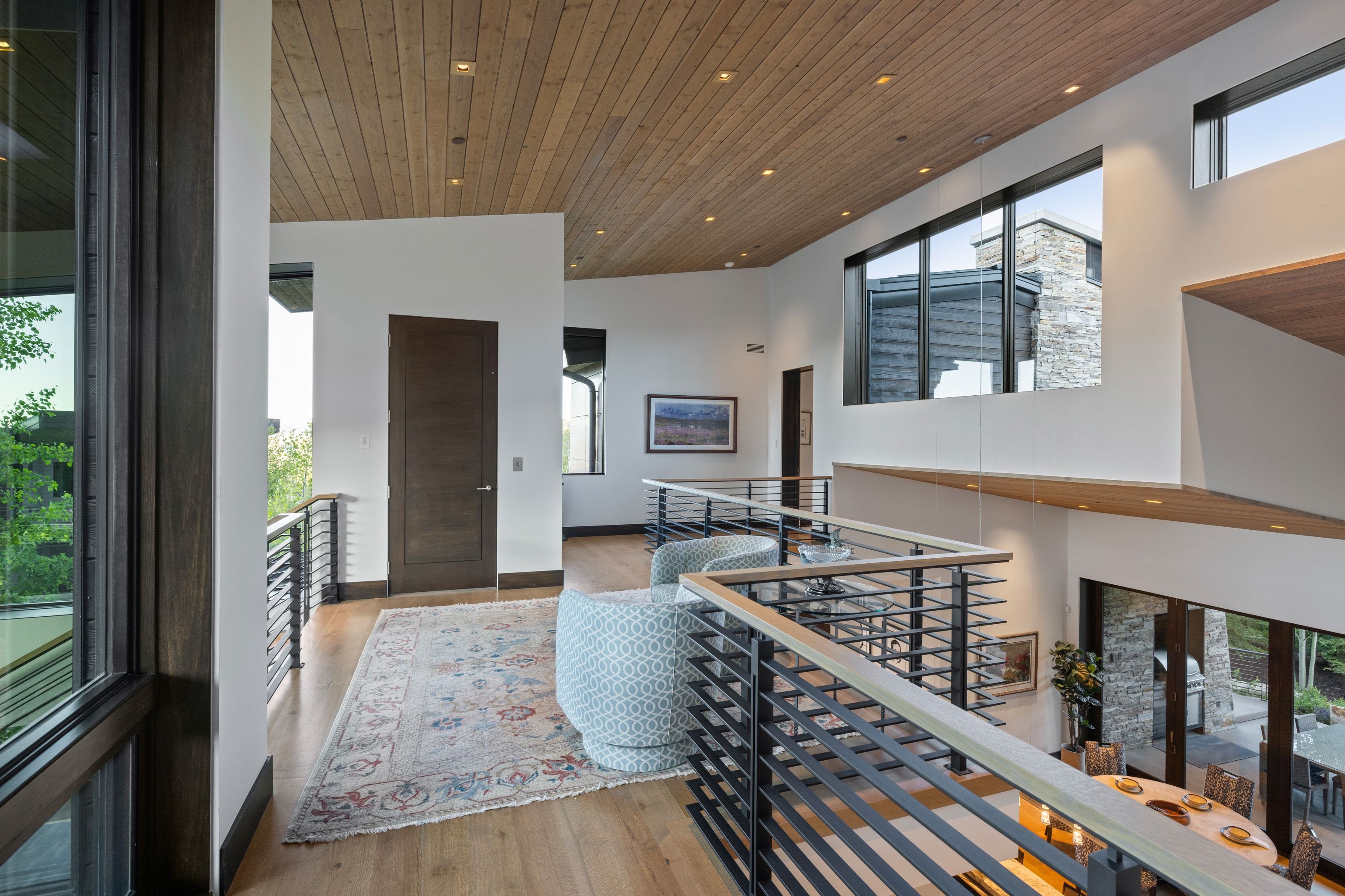 Upper-level landing featuring wood-finish flooring, a wood-paneled ceiling, and recessed lighting