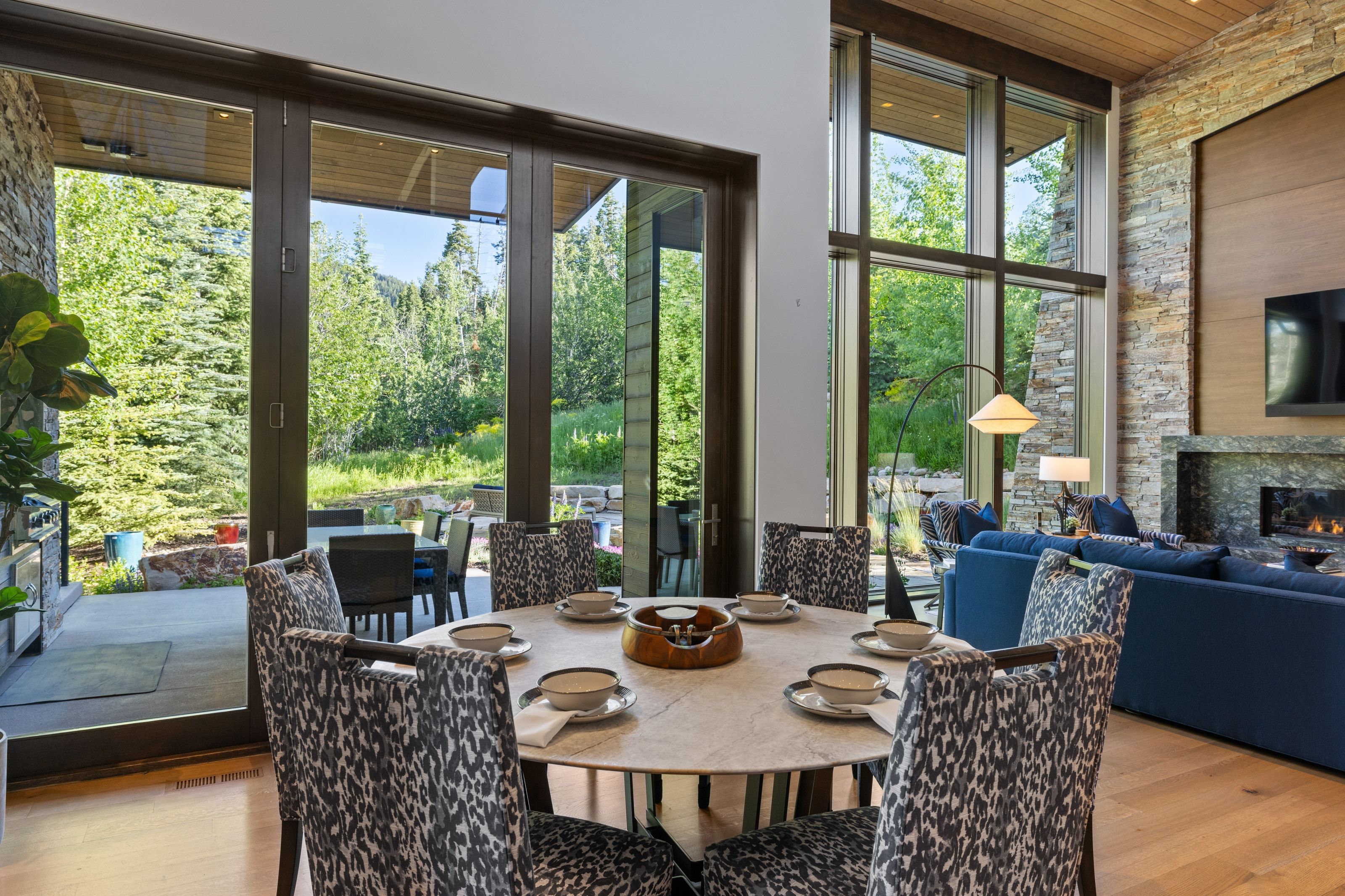Dining area featuring wood-finish flooring and a stone-clad accent wall