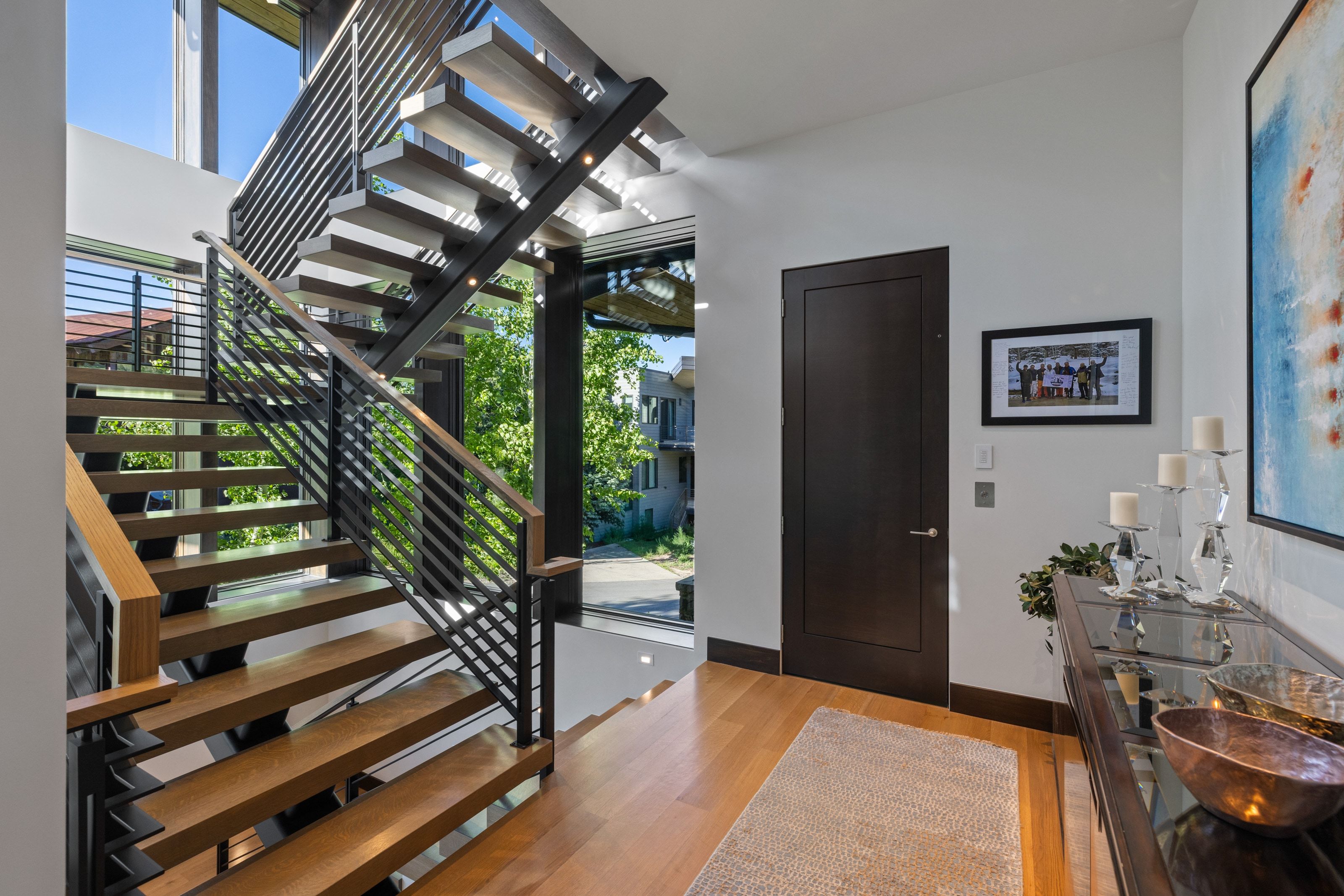 Floating staircase featuring wood treads and black metal railings