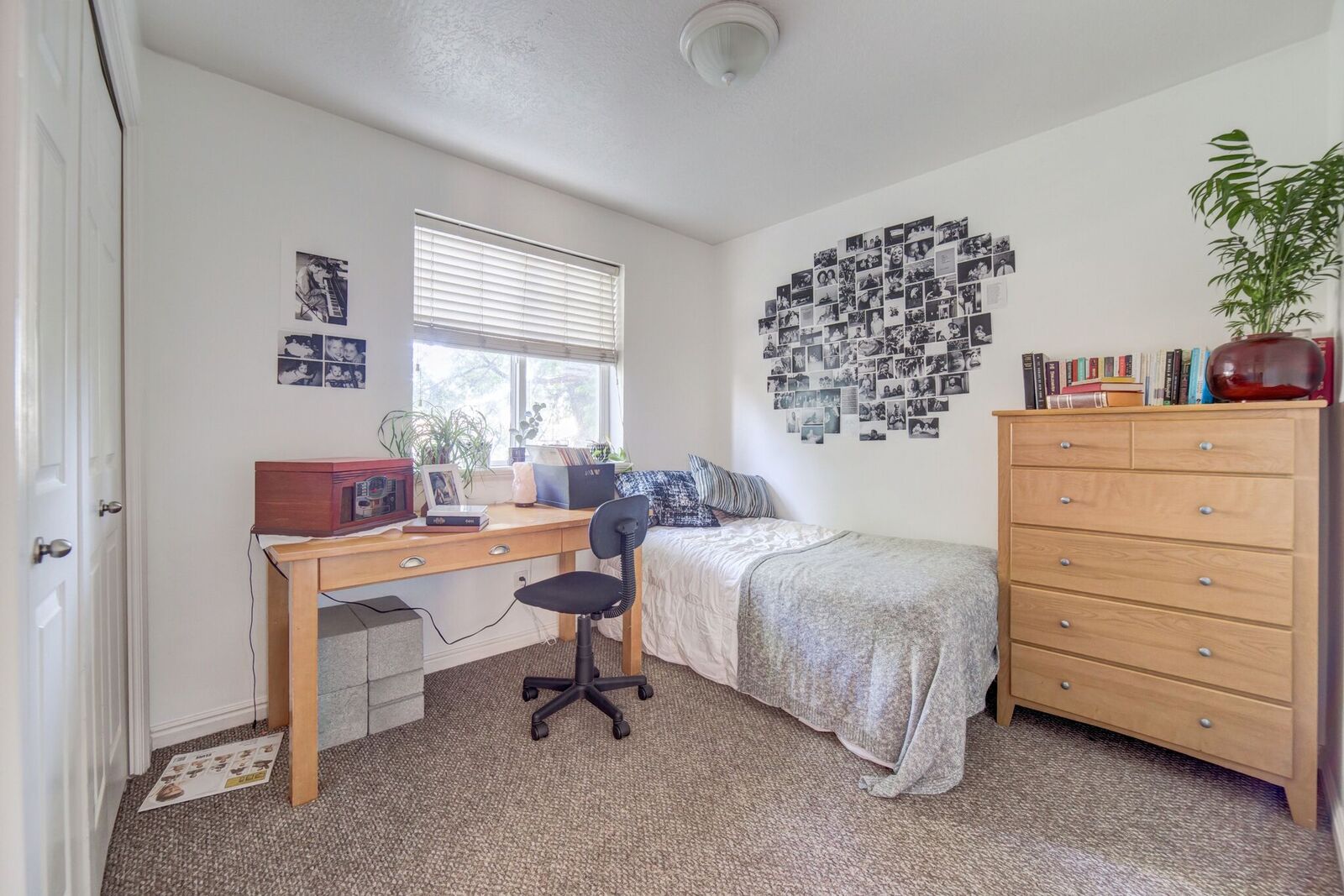 Bedroom featuring a window with horizontal blinds, carpet flooring, and a flush-mount ceiling light