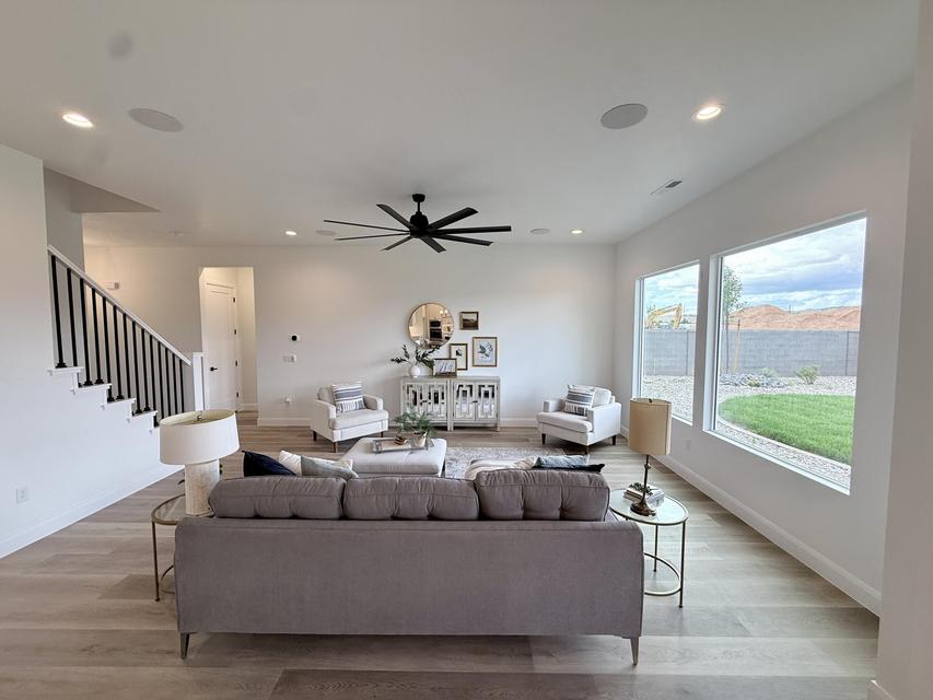 Bright living area featuring light wood-finish flooring and recessed lighting