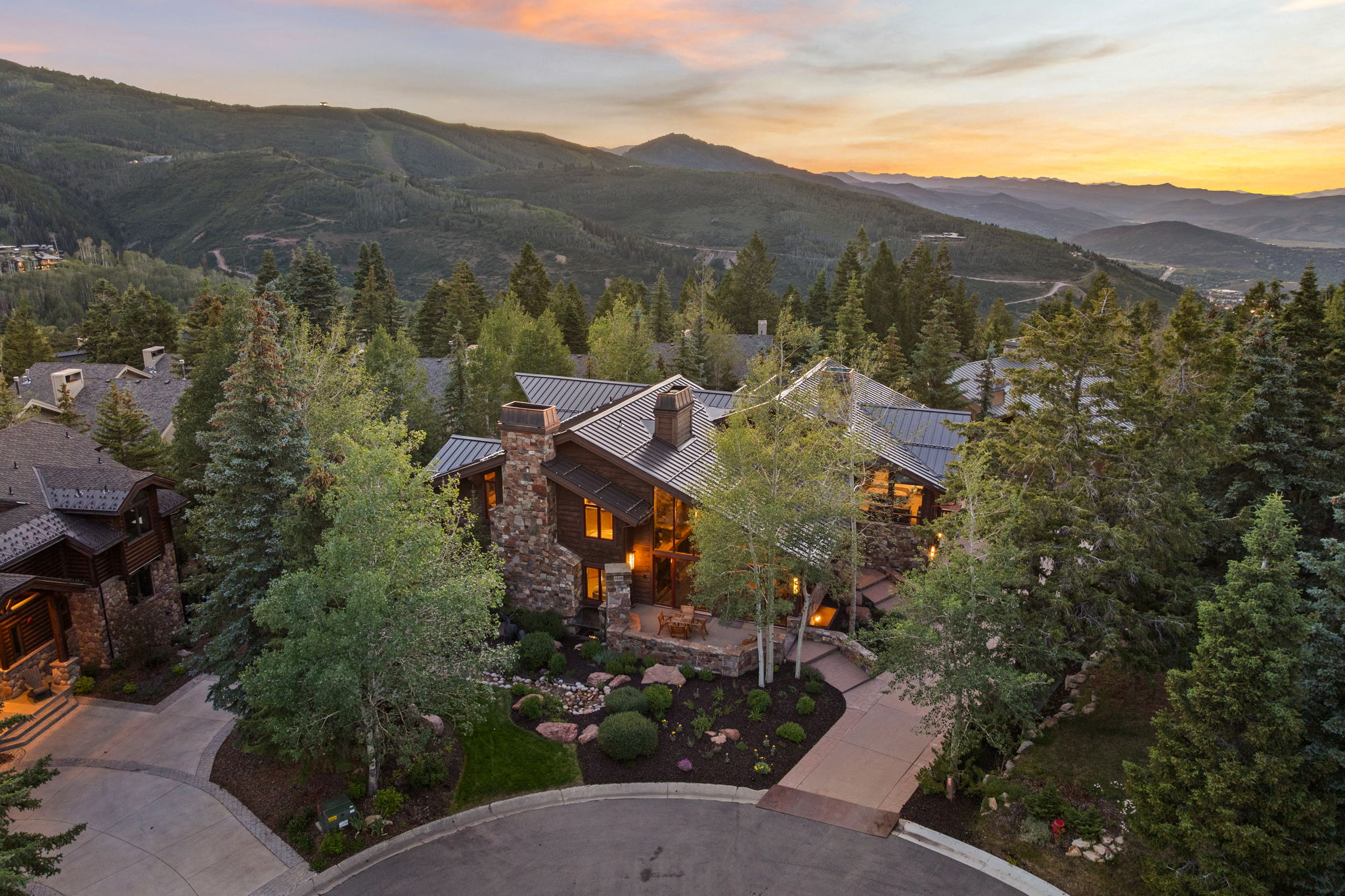Mountain-style residence featuring natural stone and wood siding