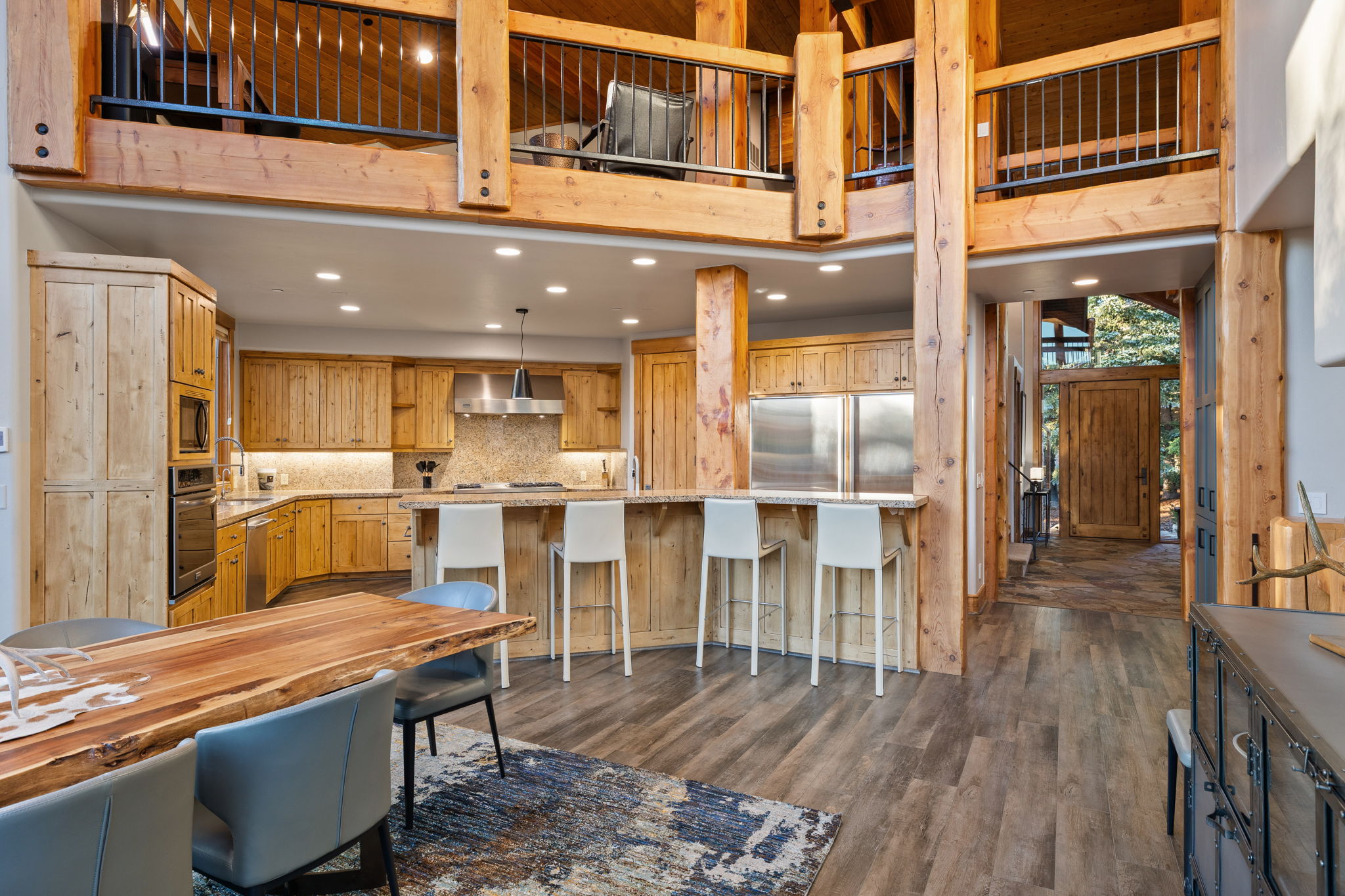 Spacious kitchen featuring wood cabinetry, stainless steel appliances, and a breakfast bar with seating