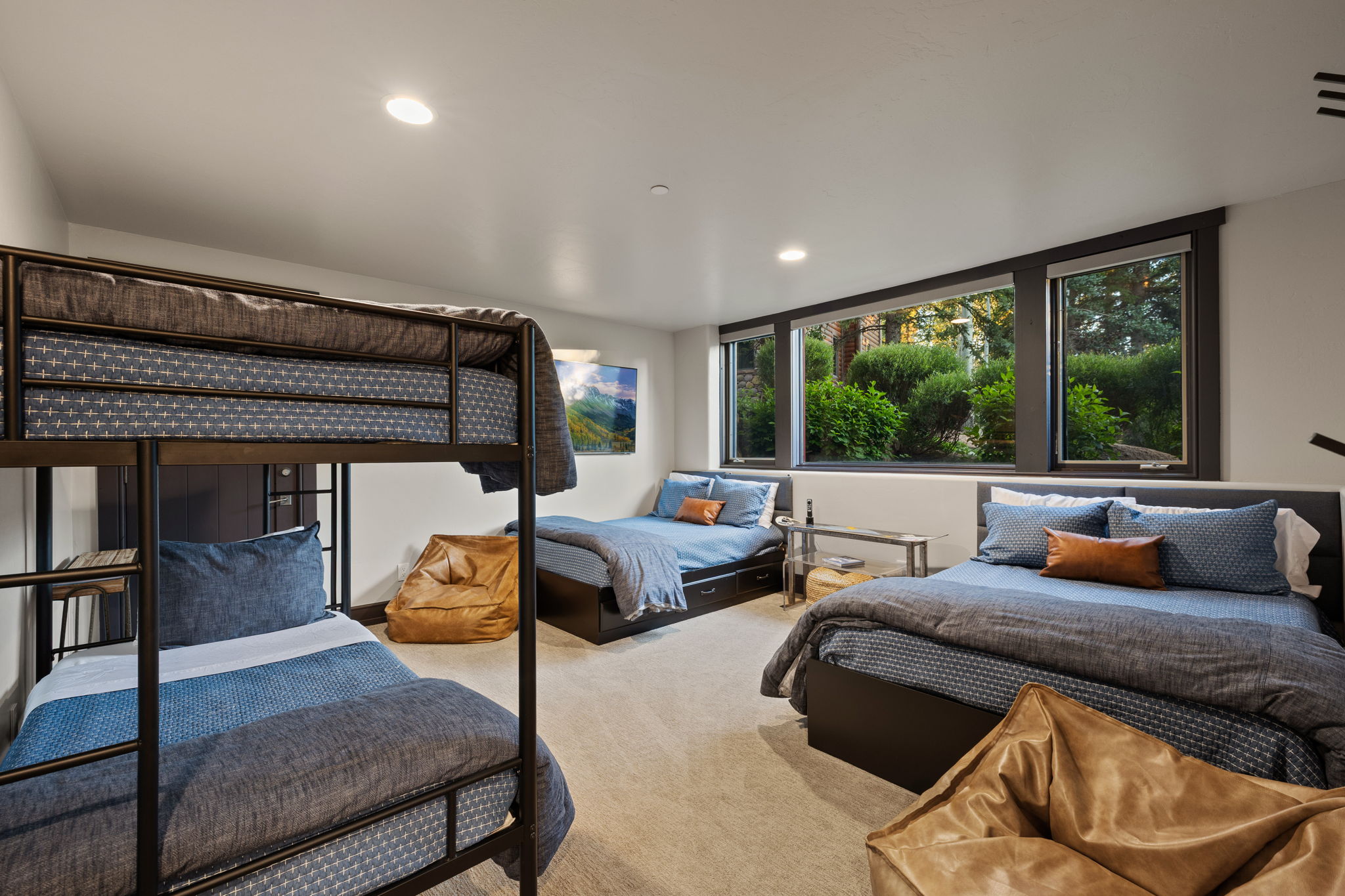 Spacious room featuring a large window array, recessed lighting, and soft carpeting