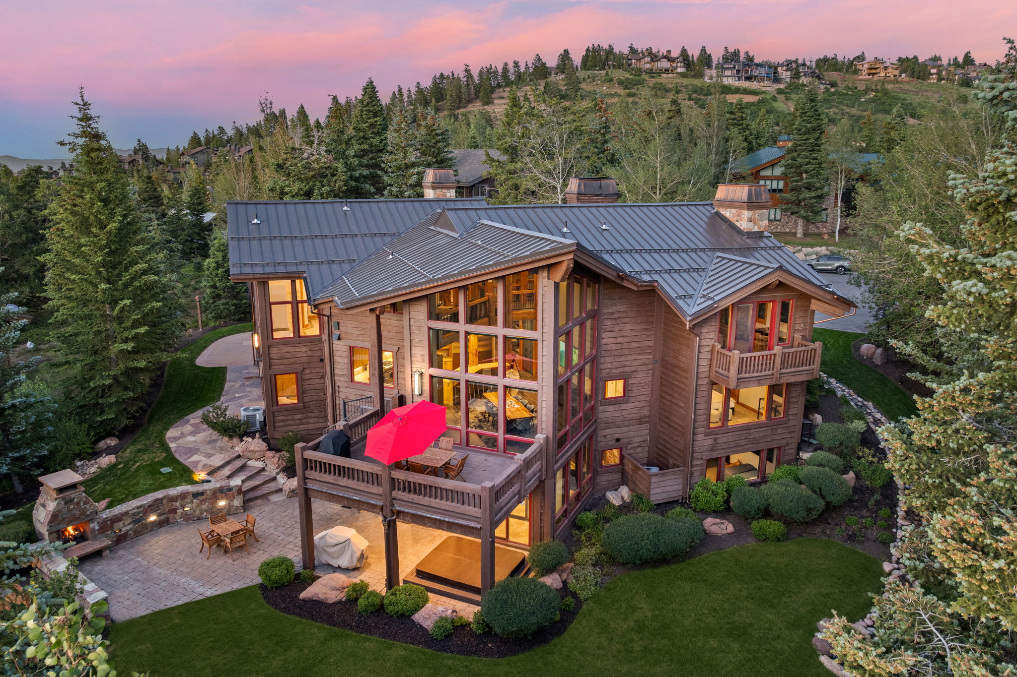 Contemporary mountain residence with a multi-level design, featuring natural wood siding and a metal roof