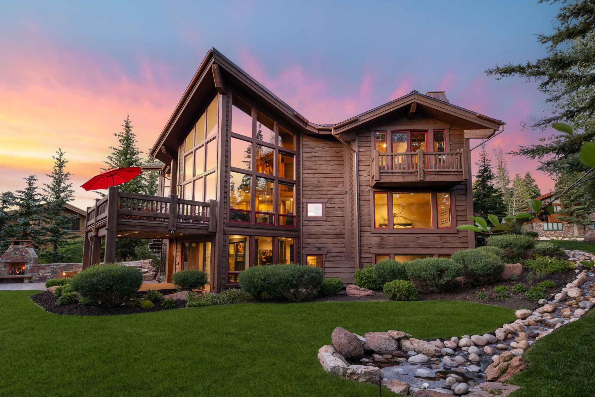 Multi-story cedar-sided residence with expansive windows