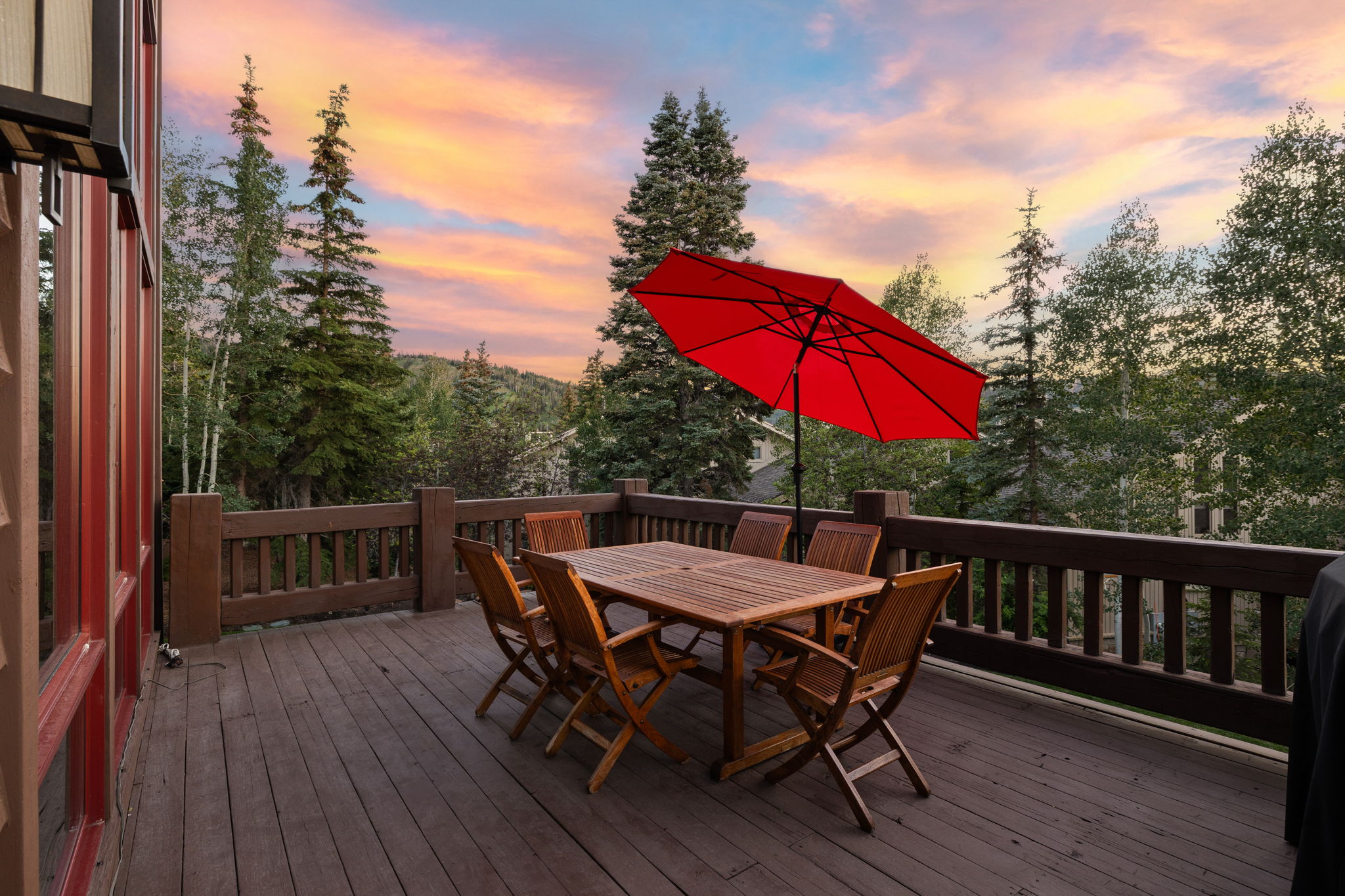 Spacious outdoor deck featuring wide plank wood flooring and sturdy wood railings