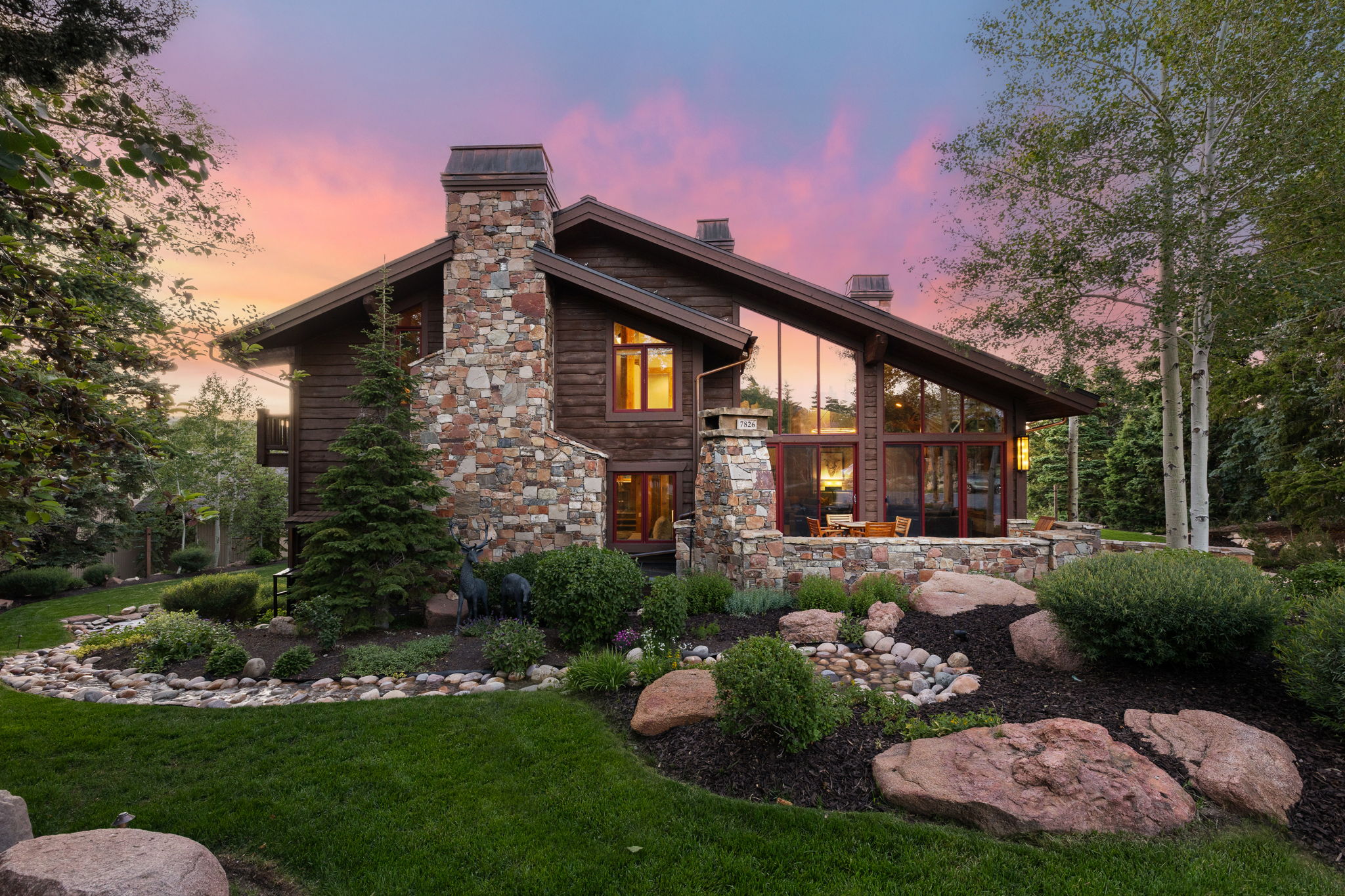 Rustic wood siding exterior with a prominent stone chimney
