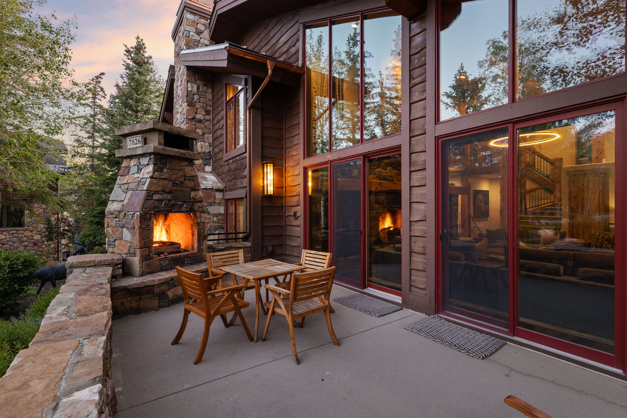 Outdoor stone fireplace with a stone chimney and stone wall cap