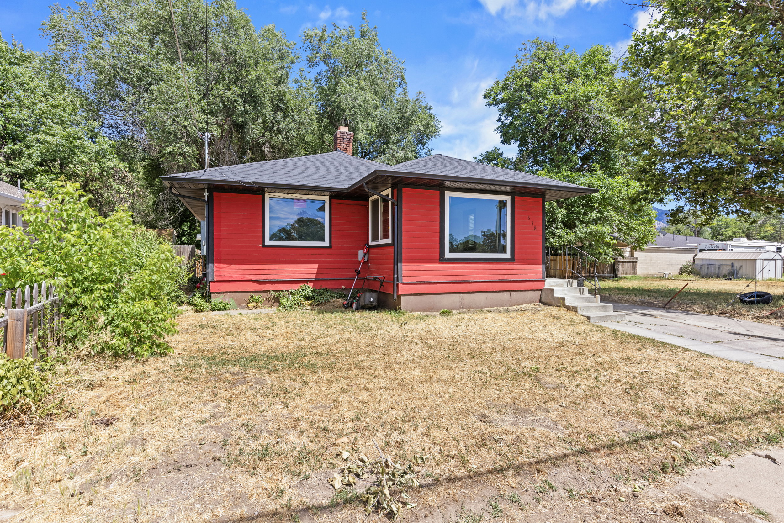 Red exterior siding with black trim around windows