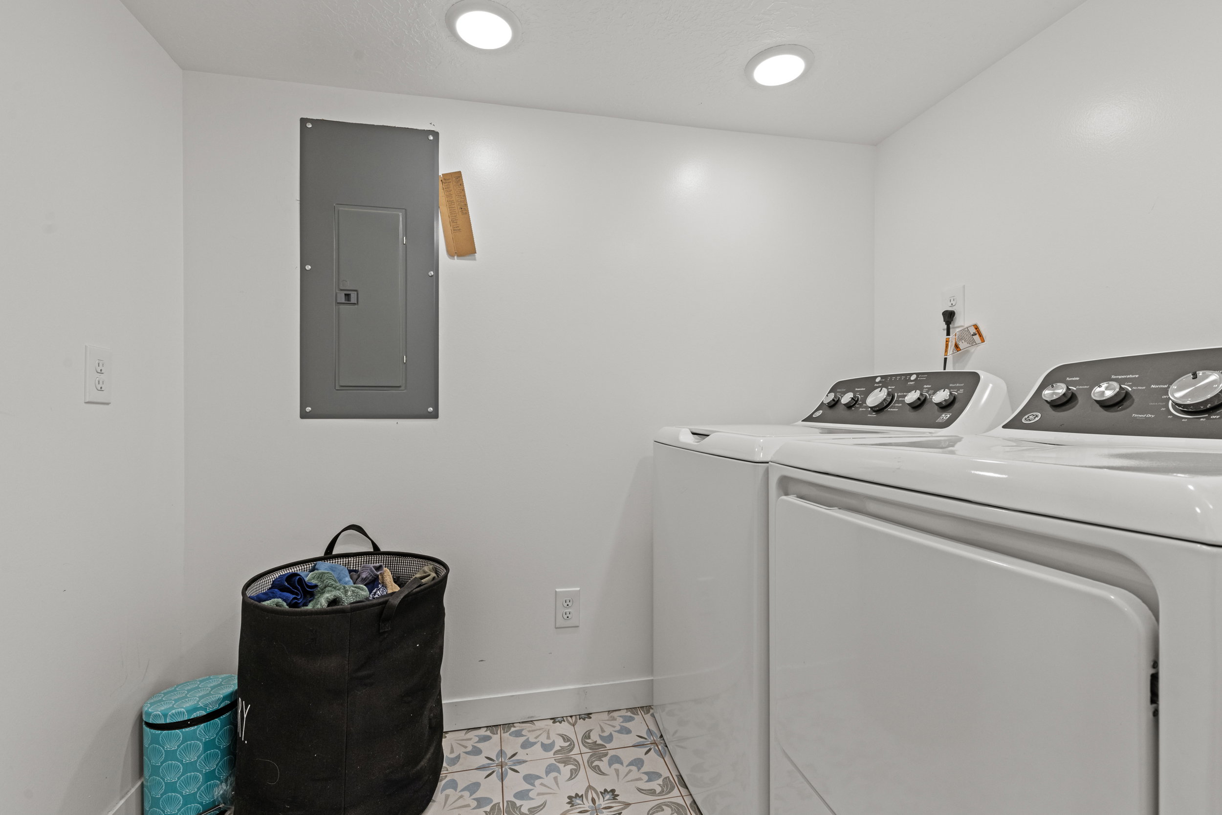 Utility space featuring patterned floor tile, white walls, and recessed lighting