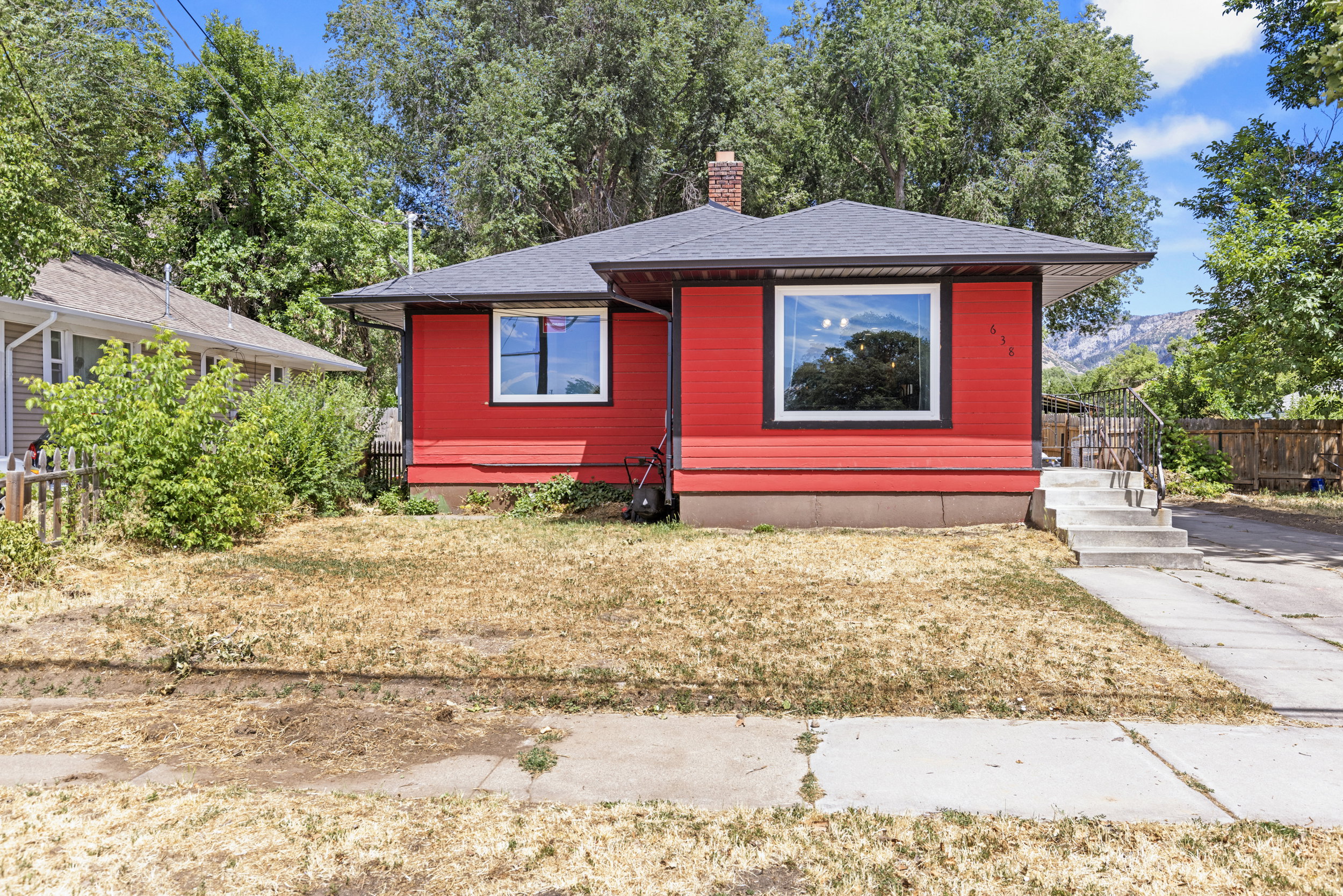 Red exterior siding with black trim and a dark-shingled roof