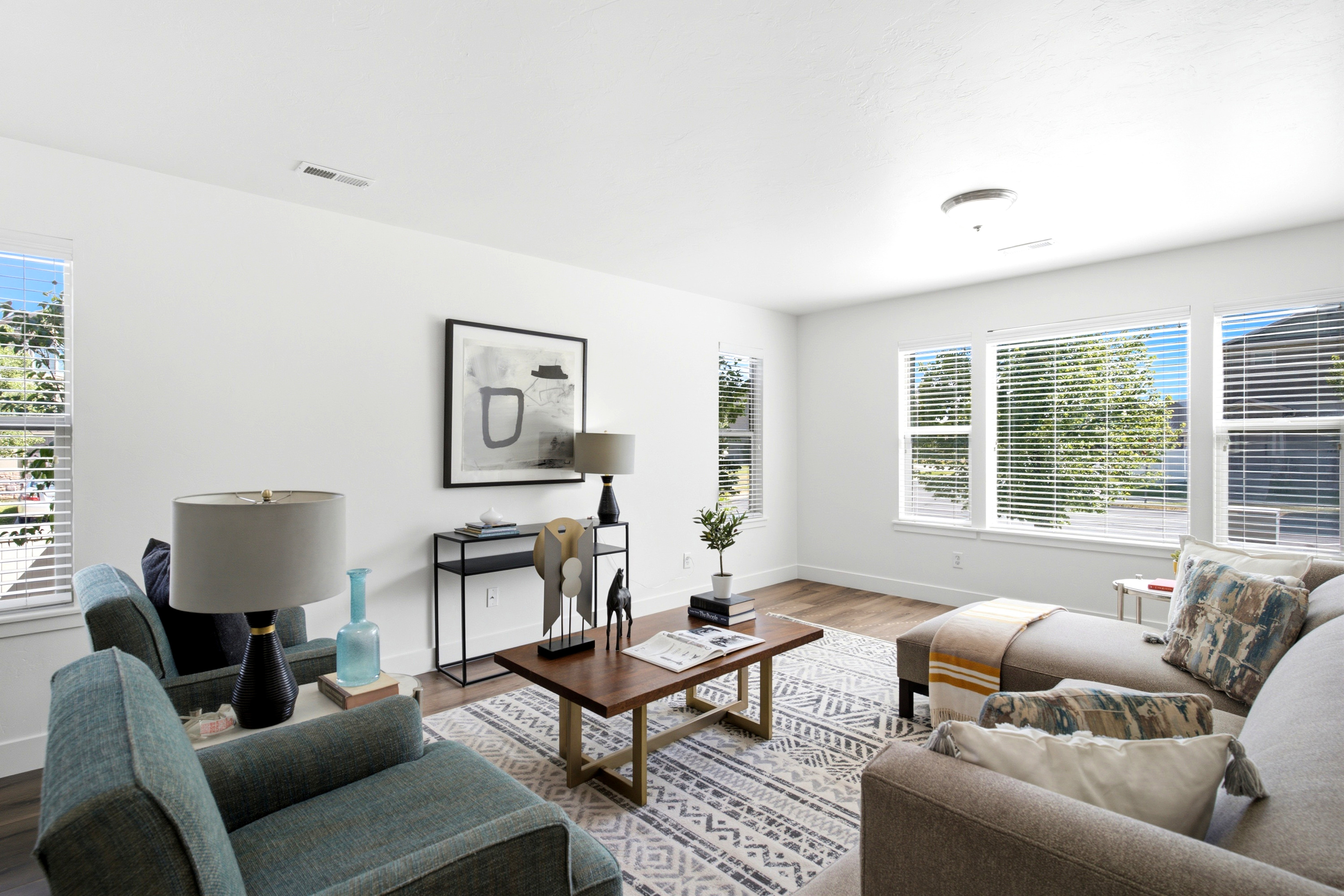 Bright living area featuring white walls and wood-finish flooring