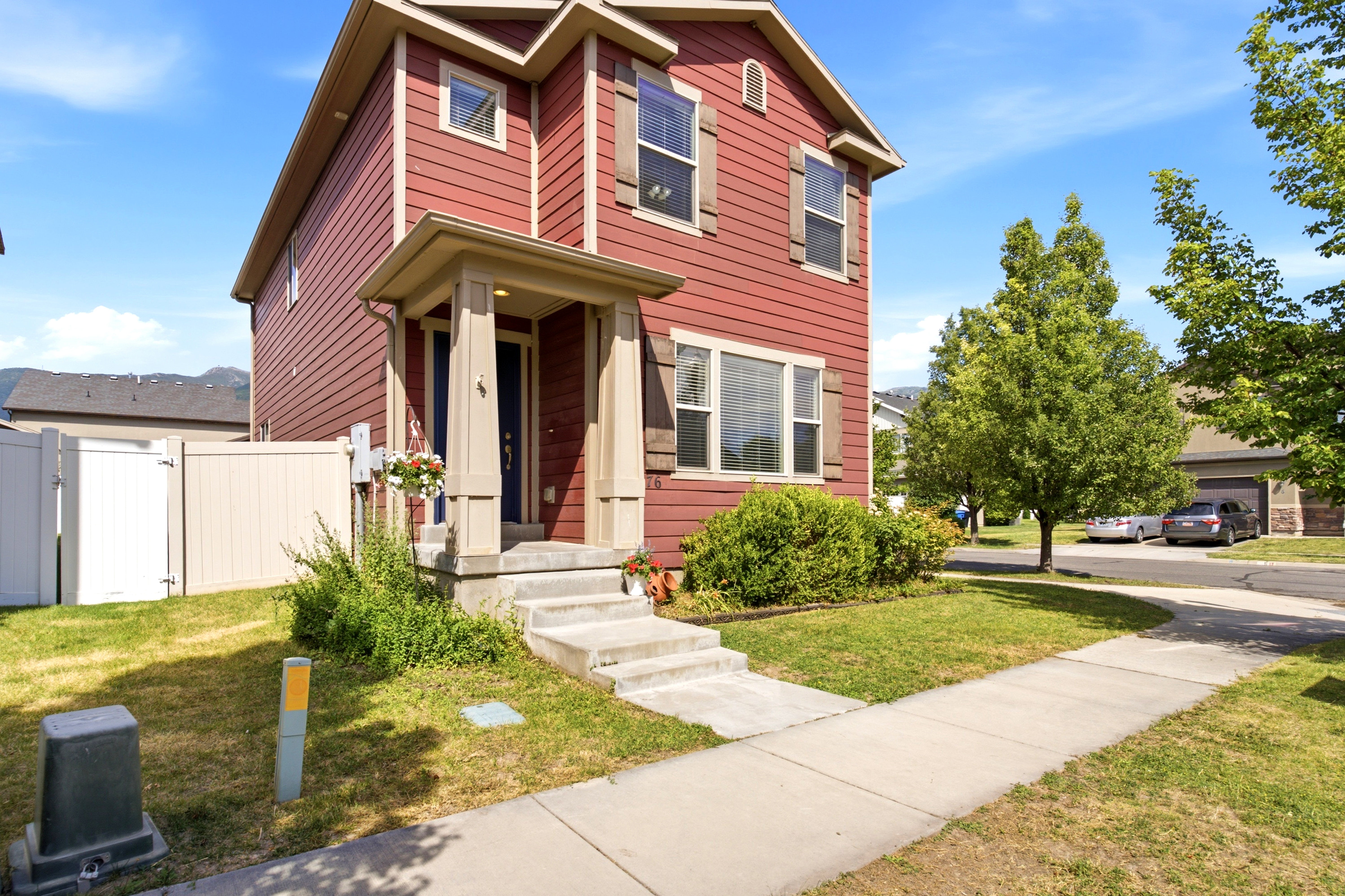 Red exterior siding with contrasting brown shutters and trim