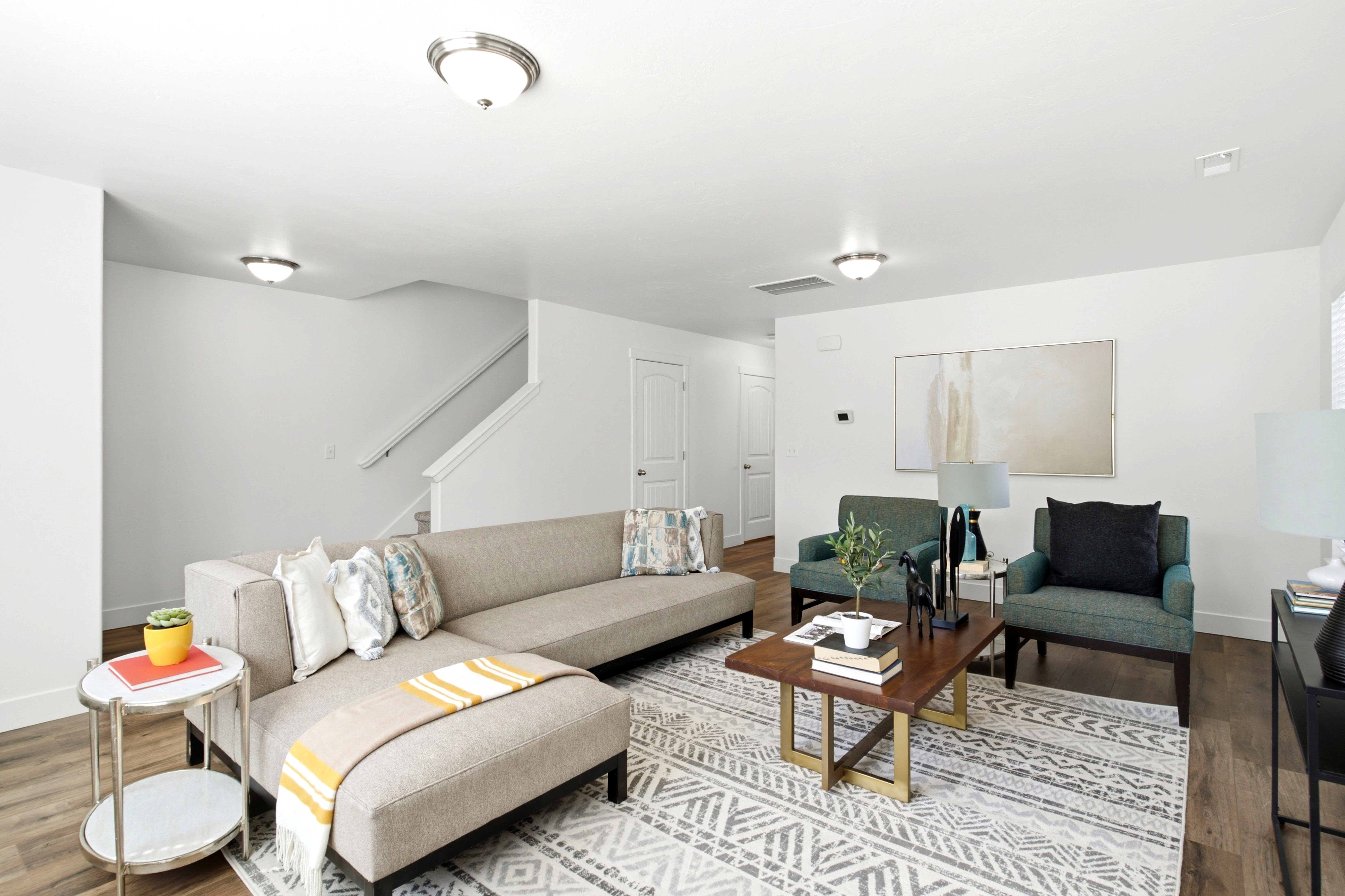 Open-concept living area featuring wood-finish flooring, white walls, and recessed lighting
