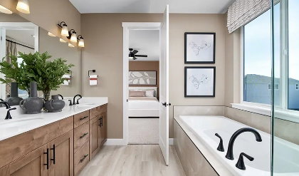 Rendering photo only. Actual finishes may vary. Bathroom featuring an elongated soaking tub with matte black fixtures, a double vanity with wood-finish cabinetry, white countertops, and wood-finish flooring