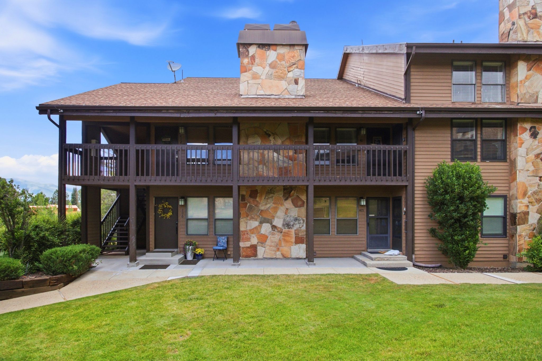 Multi-level exterior featuring stone accents and wood siding