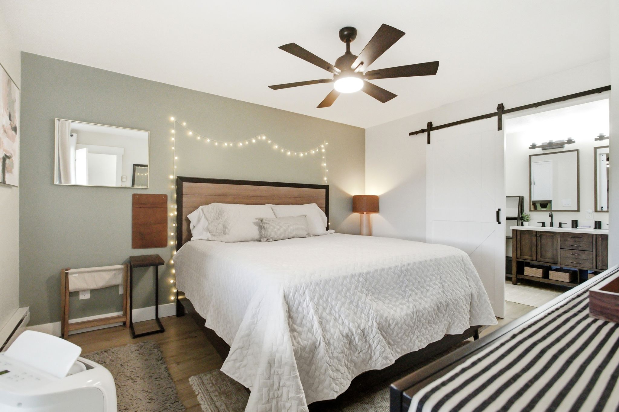 Bedroom featuring wood-finish flooring and a ceiling fan with integrated lighting