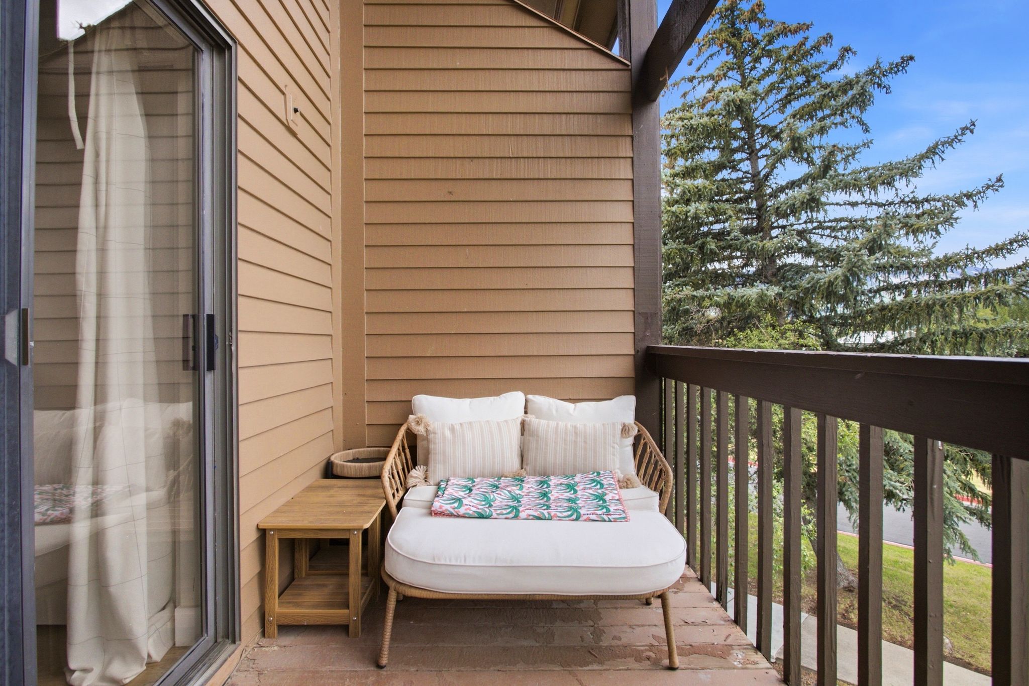 Private balcony with horizontal siding and a sliding glass door