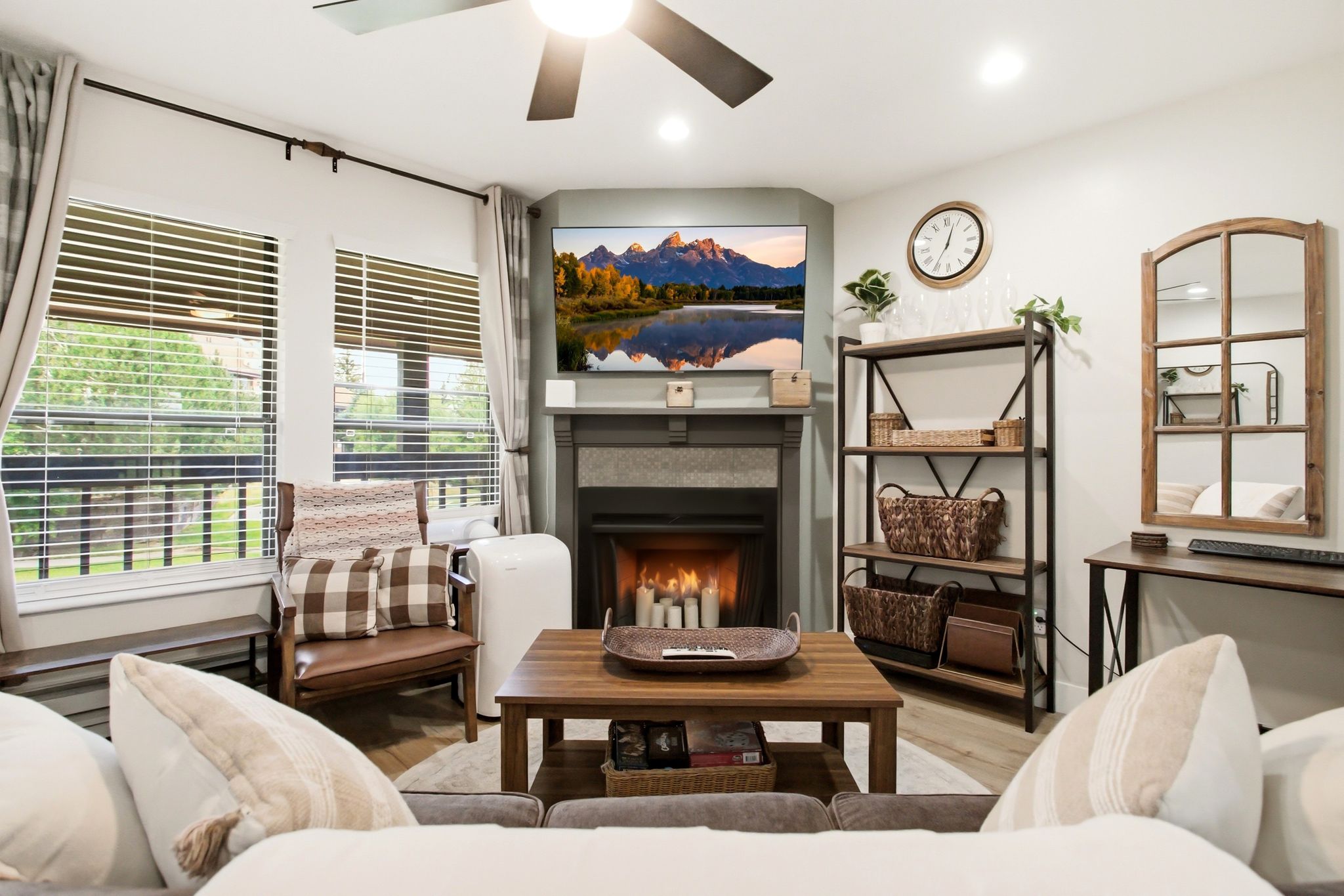 Living area featuring wood-finish flooring and a ceiling fan with integrated lighting