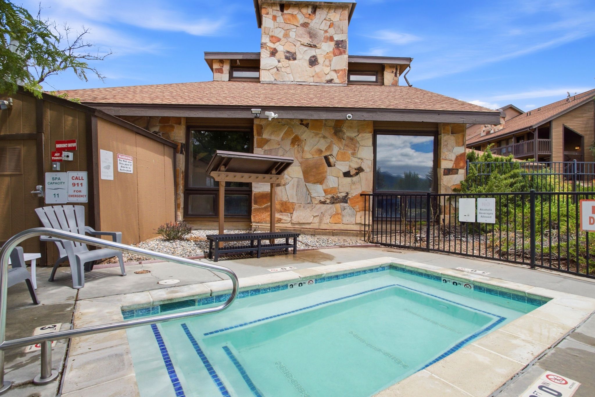 Outdoor spa with concrete decking and metal handrails