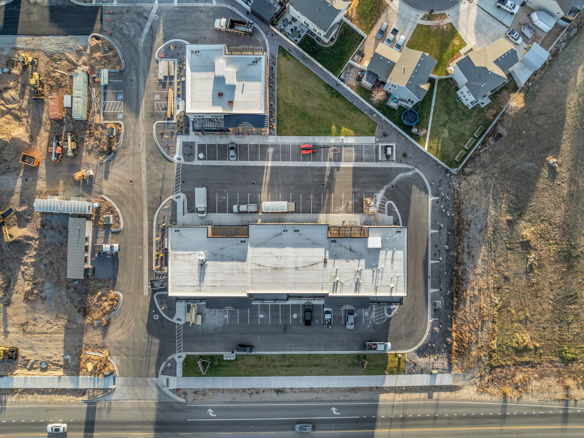 Commercial structures featuring expansive parking areas and direct road access