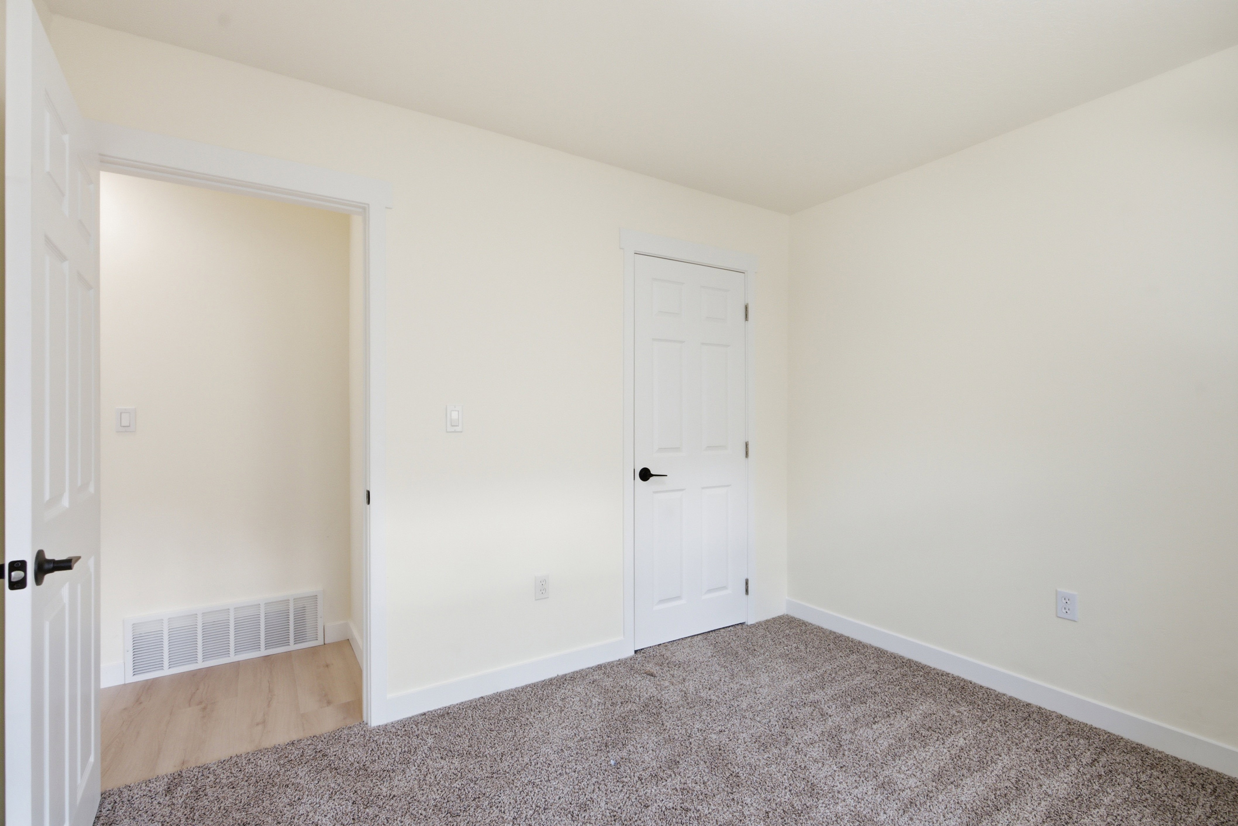 Neutral-toned interior featuring plush carpeting and light-colored walls