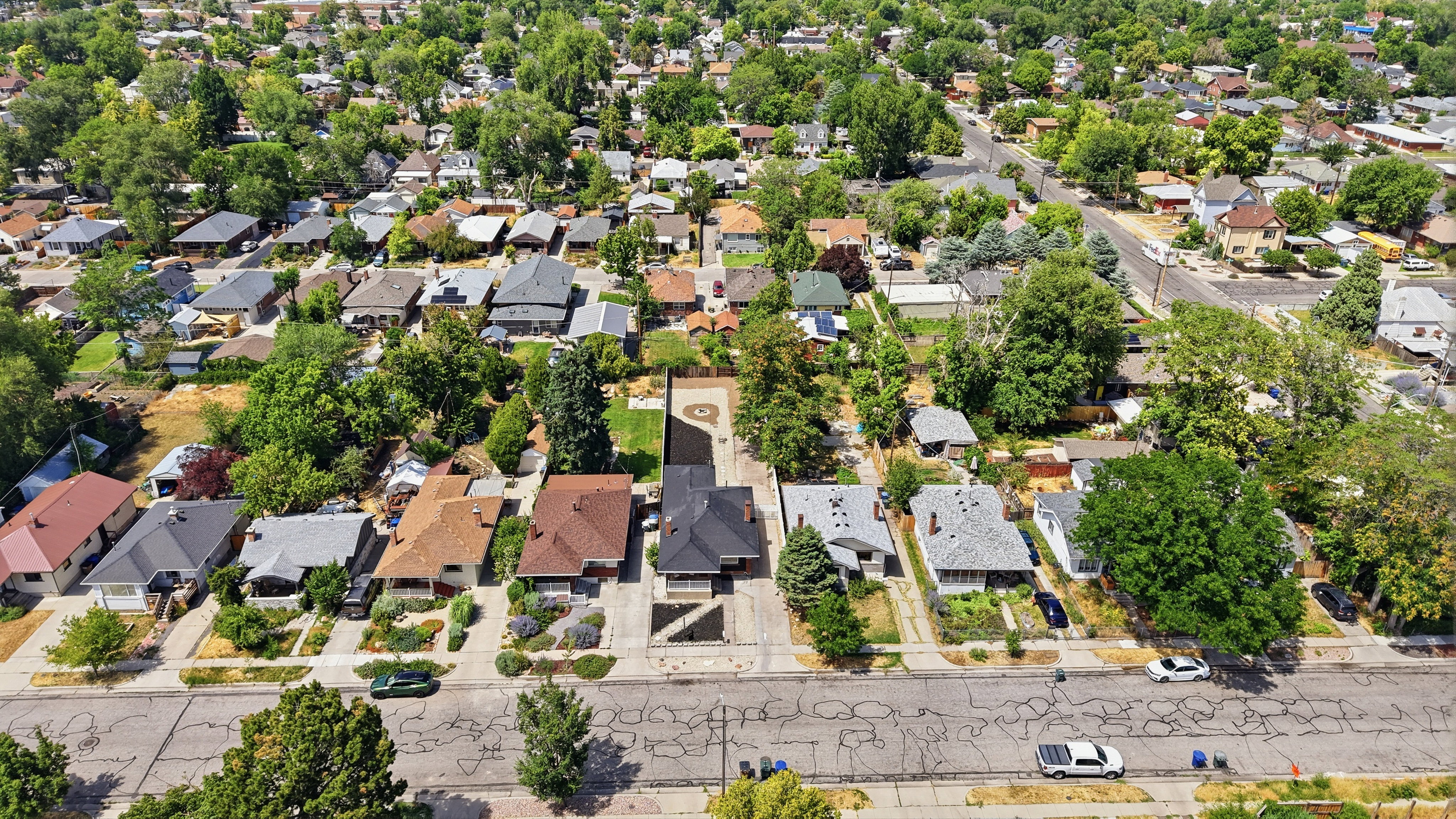 Aerial perspective showcasing a residential neighborhood with mature tree coverage