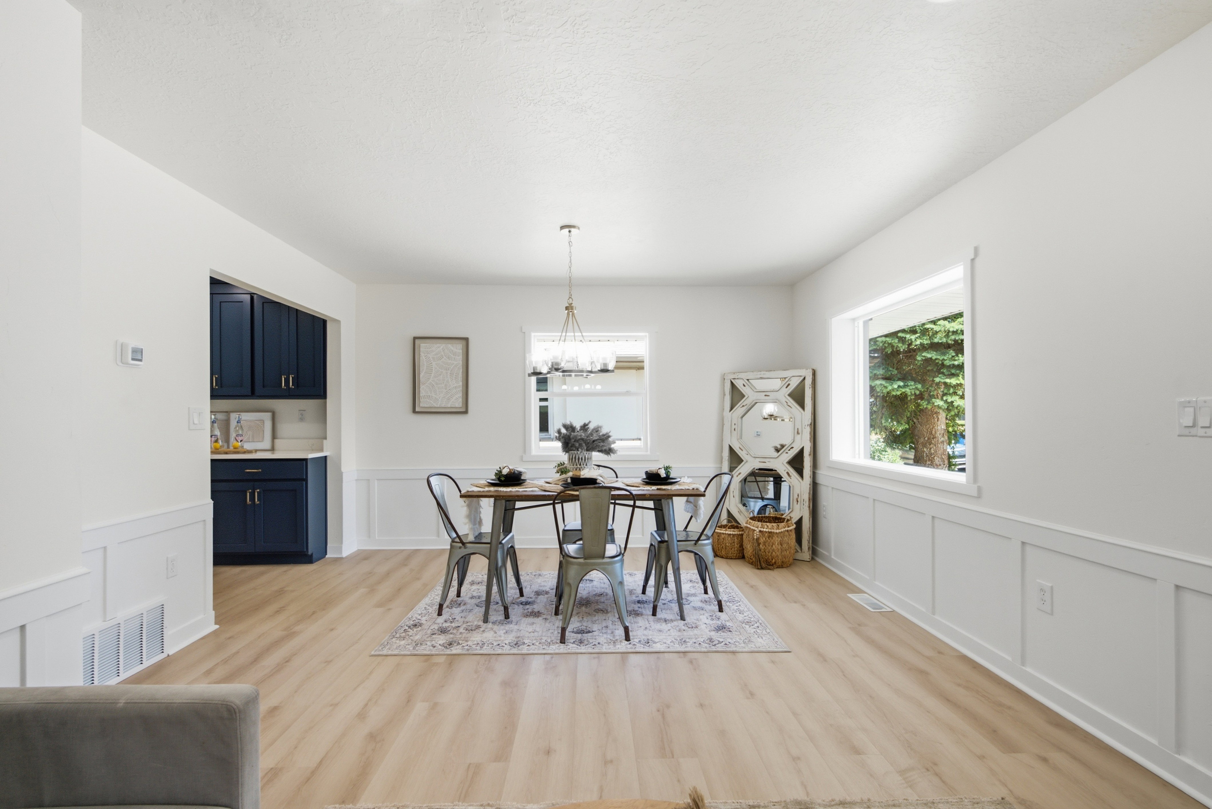 Spacious interior featuring light wood-finish flooring, white walls, and wainscoting