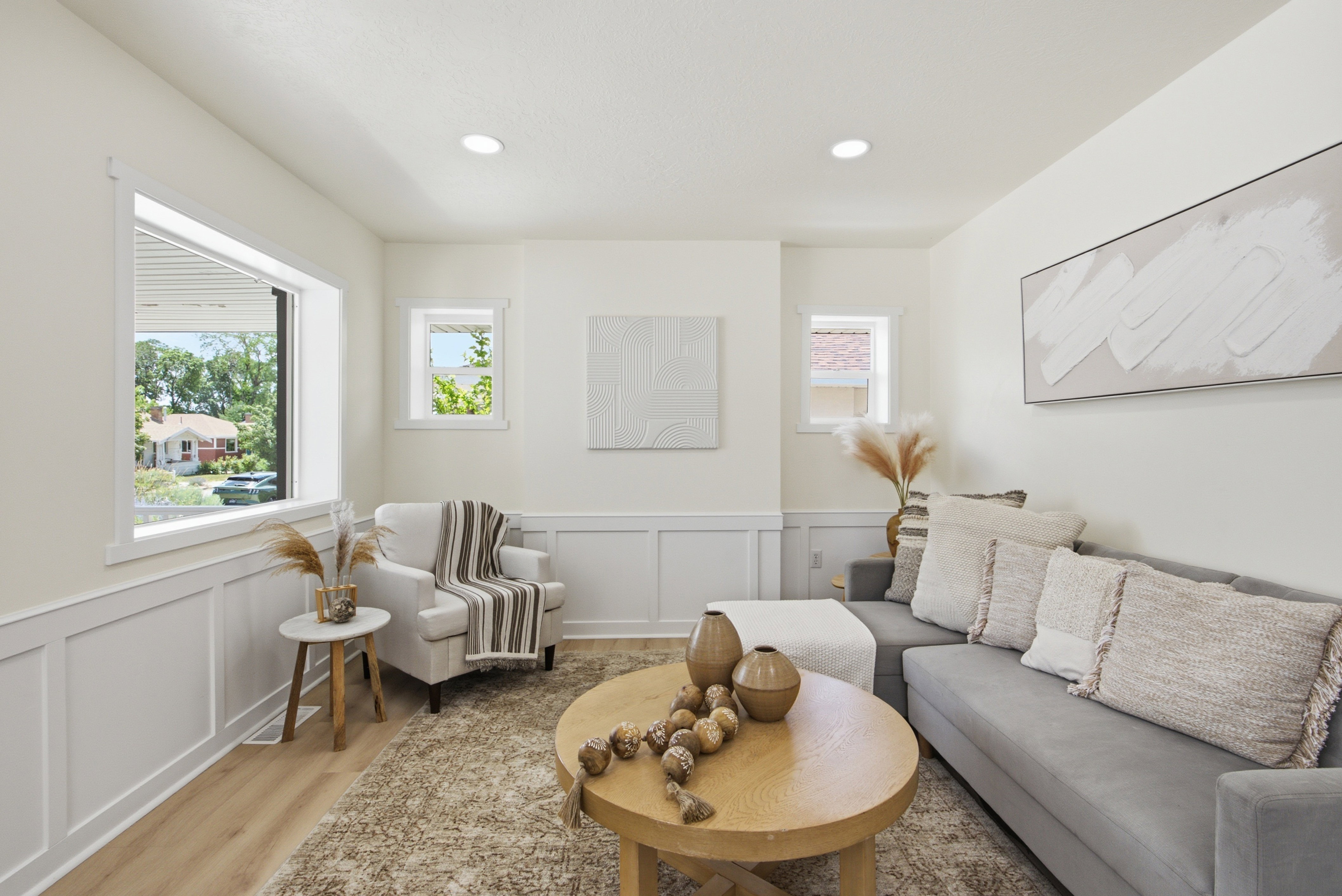 Living area featuring light wood-finish flooring and recessed lighting