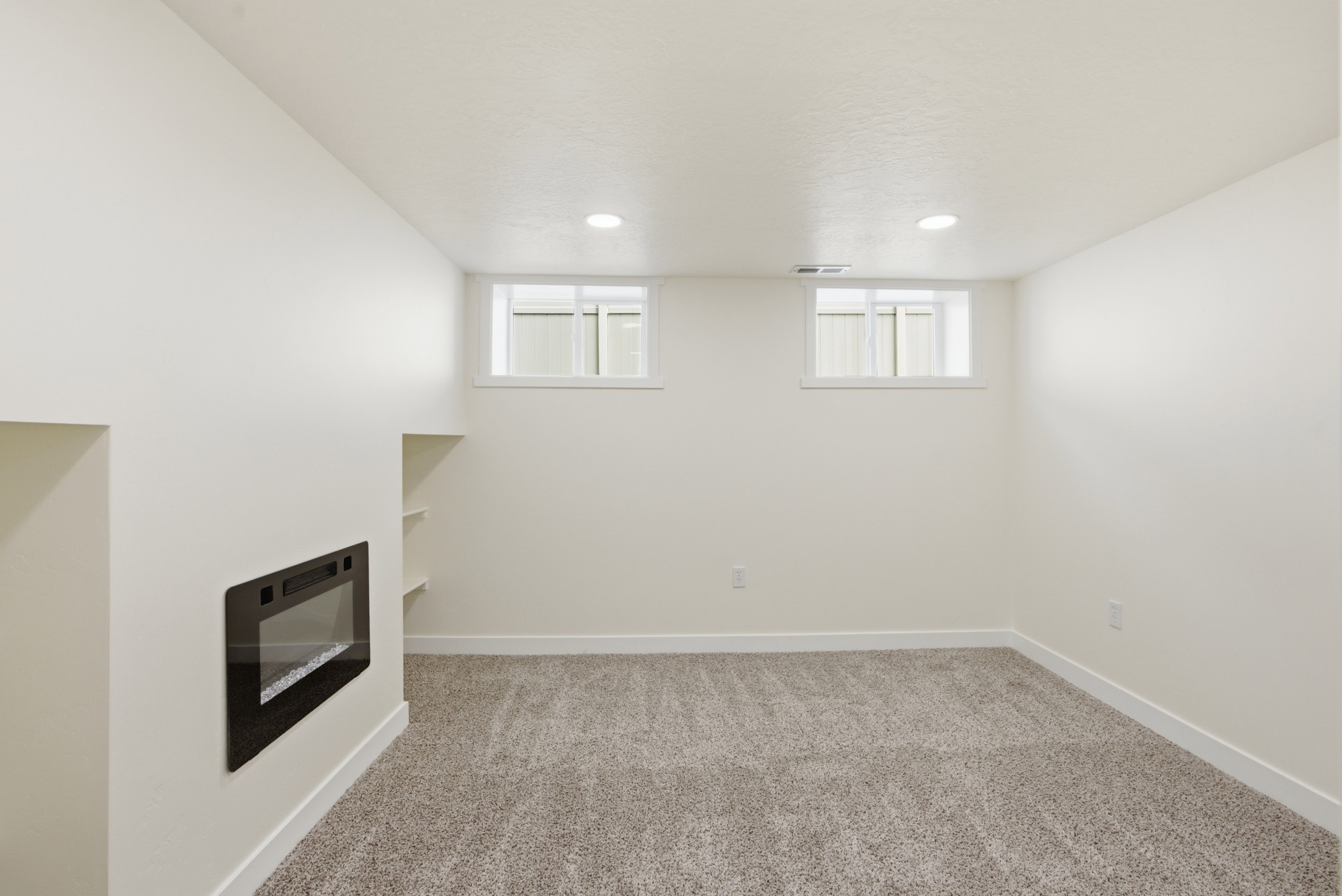 Recessed wall-mounted fireplace with a black surround